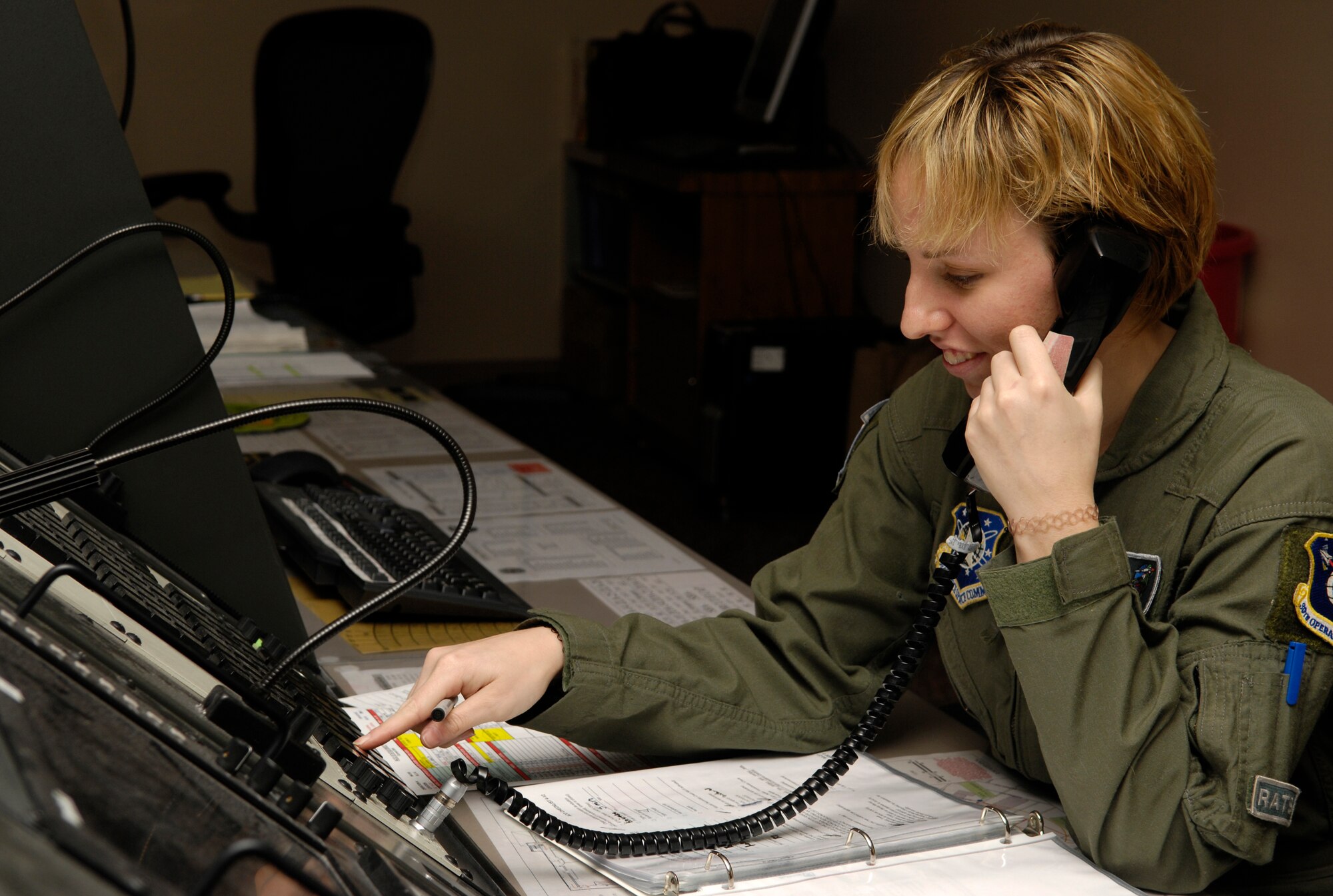 VANDENBERG AIR FORCE BASE, Calif. -- Senior Airman Jillian Voyles, a 2nd Range Operations Squadron aerospace control officer, uses a secure line to make a phone call during a training scenario on Jan. 14. Aerospace control officers ensure launch hazard areas are clear of boats, trains, aircraft, and personnel on oil rigs during launch operations. The scenario is the deciding factor on who is selected to be on the elite 30th Space Wing Guardian Challenge Team. Air Force Space Command hails GC as the only space war fighter competition in the Air Force. The competition pits the "best of the best" space war fighters against each other, determining the top space wing teams in the Air Force. The event captures the essence of competition through rigorous evaluation and increases the overall capabilities of operations teams to perform their missions. (U.S. Air Force photo/Airman 1st Class Christian Thomas)
