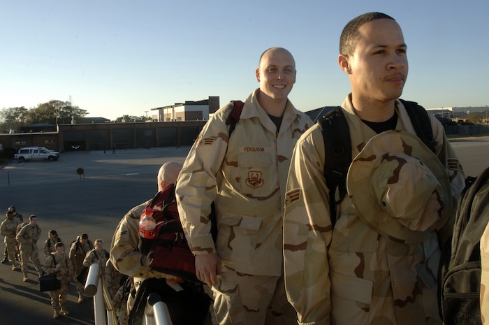 Senior Airmen Alton Lee, 437th Airlift Maintenance Squadron, and John Ferguson, 437th Logistics Readiness Squadron, and more than 35 Airmen from different organizations on Charleston AFB board the rotator aircraft bound for a forward deployed location in Southwest Asia Jan. 15. (U.S. Air Force photo/Staff Sgt. April Quintanilla)