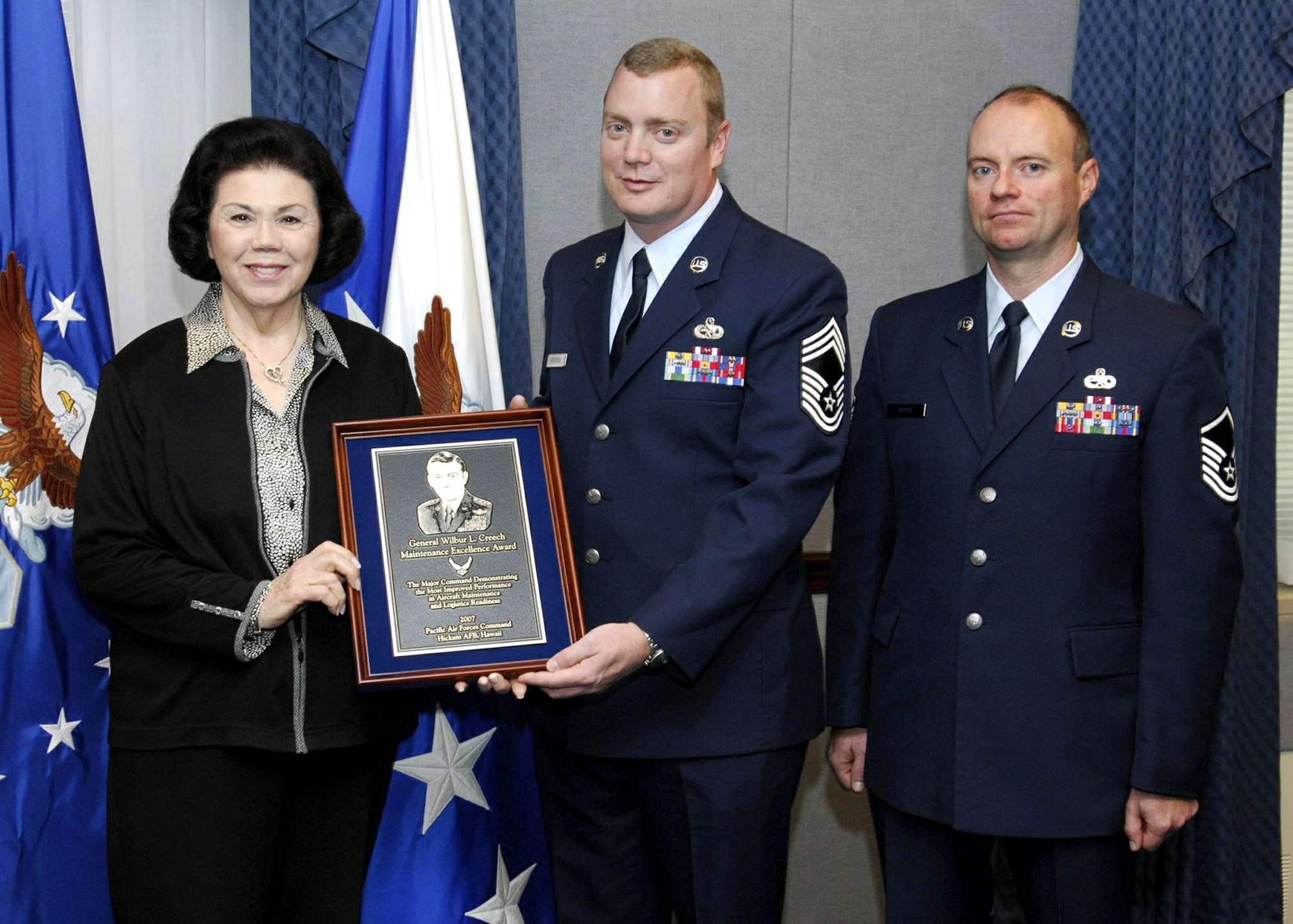 Carol Creech, Chief Master Sgt. Robert L. Norcross II and Master Sgt. Jeffrey Soots pose with the Gen. Wilbur L. Creech Maintenance Excellence Award during a ceremony Jan. 16 at the Pentagon. Chief Norcross and Sergeant Soots accepted the award on behalf of the 10,000-plus maintainers and logisticians in Pacific Air Forces command. Mrs. Creech is the wife of the general, who passed away in 2003. (U.S. Air Force photo/Michael Pausic) 


