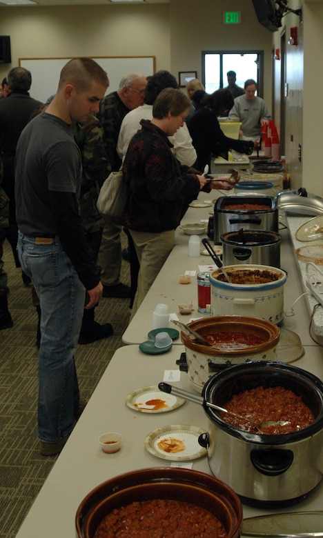 BUCKLEY AIR FORCE BASE, Colo. -- Members of Team Buckley line up to sample chili brought in from all over the base for the Chapel's 5th Annual Chili Cook-Off Jan. 16. The cook-off was the taste of this months fellowship luncheon, which is a free luncheon hosted by the Chapel on the third Wednesday of every month. (U.S. Air Force photo by Staff Sgt. Sanjay Allen)