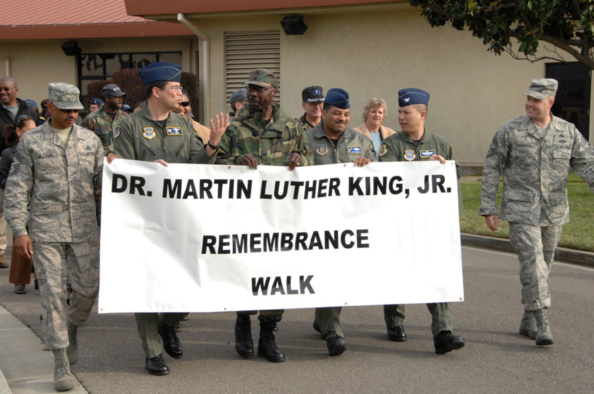 TRAVIS AIR FORCE BASE, Calif., -- Walking the walk: Members from the 349th Air Mobility Wing and the 60th AMW joined the Martin Luther King Remembrance Walk at Travis Air Force Base, Jan. 14, to celebrate the many great accomplishments of the slain civil rights leader. About 50 people turned out for the walk, leaving from 60th AMW headquarters building and walking for about 20 minutes to Chapel 1, for a ceremony there. Holding the banner from (left to right) are: 60th AMW Command Chief Master Sgt. Michael Williams; 615th Contingency Response Wing Commander, Col. Tony Hinen; 60th AMW Chaplain (Col.) Leon Page; 349th Operations Group Deputy Commander, Col. Dale Andrews, and 60th AMW Vice Commander, Col. GI Tuck. 
“I am motivated by the idea that you can have one individual like Martin Luther King inspire so many people,” said Master Sgt. Drancy Ennis, Unit Training Education Manager, 60th Maintenance Operations Squadron, who helped organize the walk. (U.S. Air Force photo by Master Sgt. Wendy Weidenhamer)
