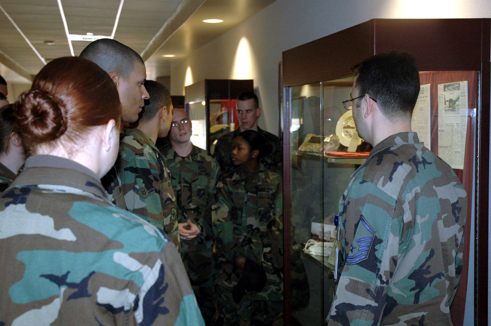 Master Sgt. Ben Rodriguez, U.S. Air Force Expeditionary Center's Mobility Operations School, talks to students from the McGuire Air Force Base, N.J., First Term Airman Center about one of the USAF EC's historical display cases Jan. 16 on Fort Dix, N.J.  The FTAC students toured the Center and learned more about its mission and people.  (U.S. Air Force Photo/Tech. Sgt. Scott T. Sturkol)
