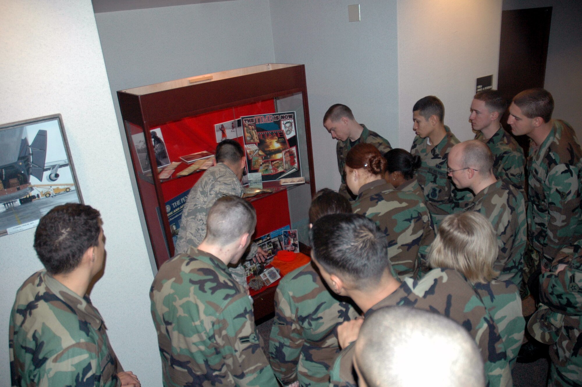 Airman 1st Class Zach Palafax, U.S. Air Force Expeditionary Center Resources Directorate, shows students from the McGuire Air Force Base, N.J., First Term Airman Center the USAF EC's Sept. 11, 2001, memorial case Jan. 16, 2007, on Fort Dix, N.J.  The FTAC students toured the Center and learned more about its mission and people.  (U.S. Air Force Photo/Tech. Sgt. Scott T. Sturkol)