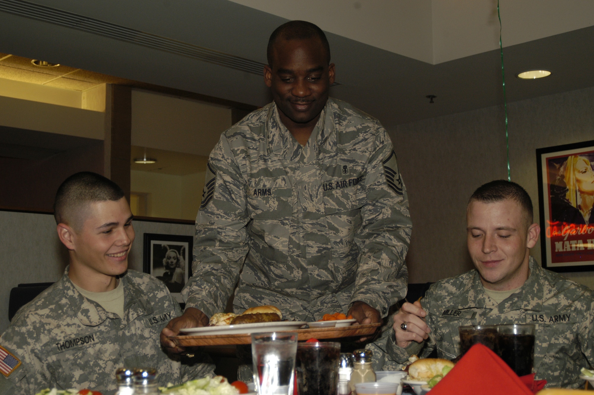 Master Sgt. Michael Arms, 436th Services Squadron first sergeant, serves (Left) Pvt. Steven Thompson and Pvt. Nathan Miller, 262 Quarter Master Battalion, at the Airmen’s Birthday Dinner at the Patterson Dining Facility Jan. 9. (U.S. Air Force photo/ Airman Shen-Chia Chu) 