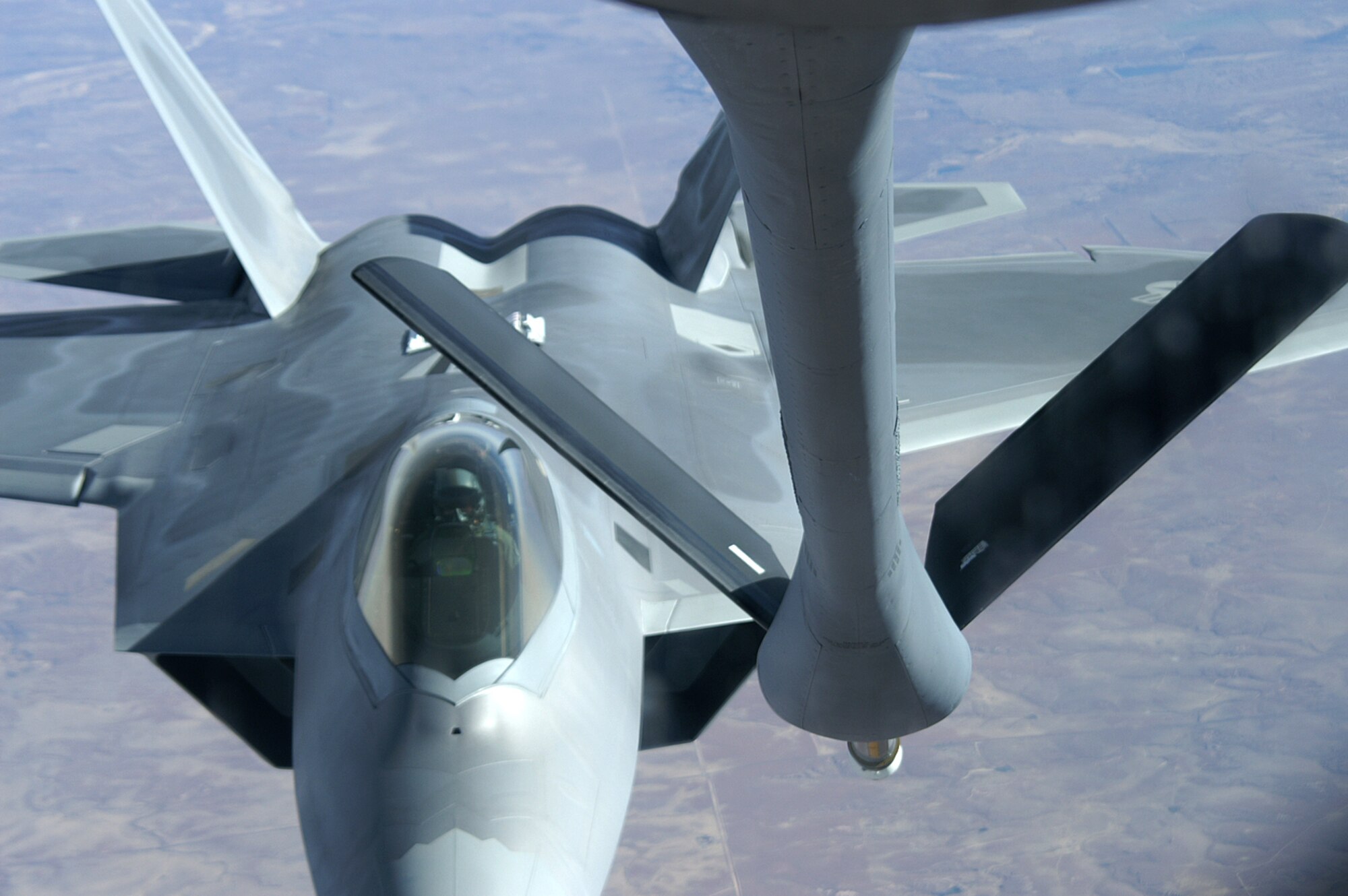 Maj. Micah Fesler, a 433rd Weapons Squadron pilot, maneuvers an F-22A “Raptor” toward the boom of a KC-135R from the 509th Weapons Squadron during a refueling operation en route here, Jan. 9. This Raptor is the first to be delivered to the 57th Wing from Lockheed-Martin, and is scheduled to be used by the U.S. Air Force Weapons School for training of PhD-level instructor pilots. (U.S. Air Force photo by Tech. Sgt. Phil Landram)