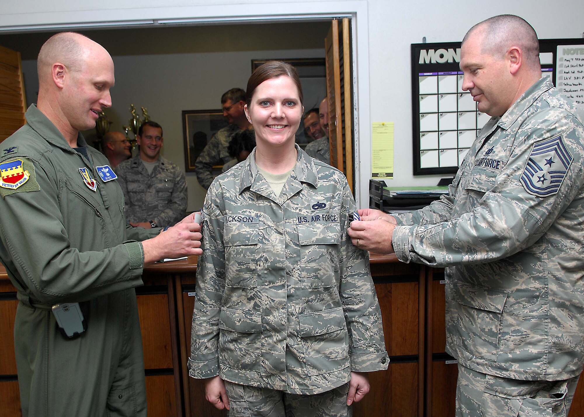 SHAW AIR FORCE BASE, S.C. -- Col. James Post, 20th Fighter Wing commander, and Chief Master Sgt. Scott Dearduff, 20th FW command chief, place congratulatory stripes on Tech. Sgt. Cheryl Jackson, 20th Equipment Maintenance Squadron, for her promotion through Stripes for Exceptional Performers Jan. 11. (U.S. Air Force photo/Airman 1st Class William Coleman)