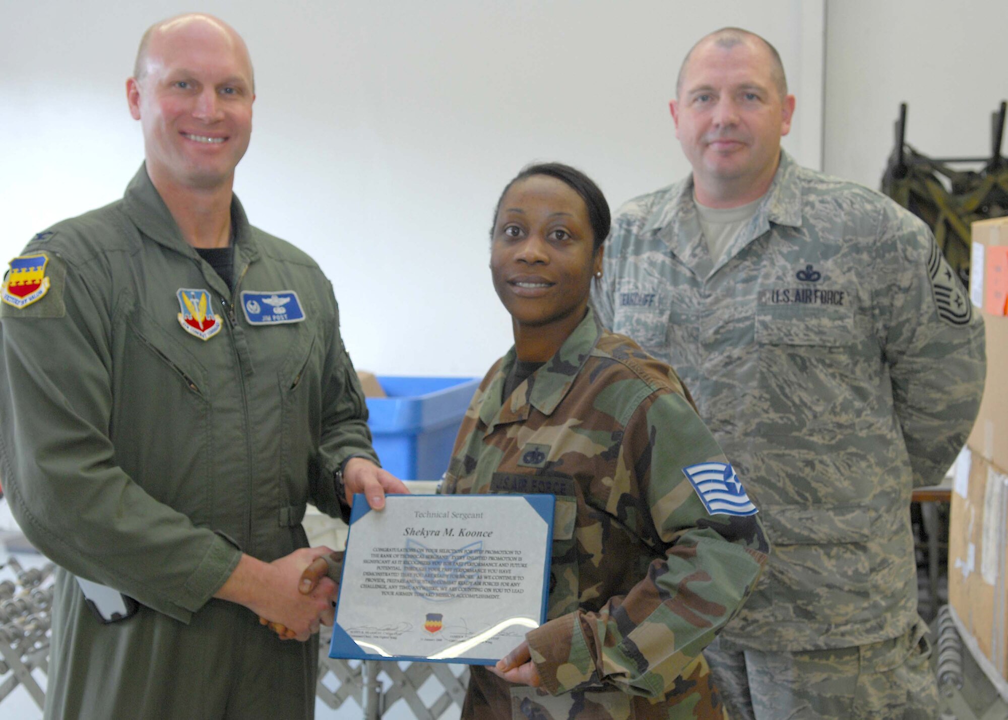 SHAW AIR FORCE BASE, S.C. -- Col. James Post, 20th Fighter Wing commander, and Chief Master Sergeant Scott Dearduff, 20th FW command chief, congratulate Tech. Sgt. Shekyra Koonce, 20th Logistics Readiness Squadron, for earning her promotion through Stripes for Exceptional Performers Jan. 11. (U.S. Air Force photo/Airman 1st Class William Coleman)