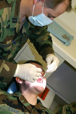 Capt. Dave Jackson, a dentist in the 419th Medical Squadron, performs a routine dental exam on fellow dentist, Maj. John Kwant, during the January UTA. (U.S. Air Force photo/Staff Sgt. Kyle Brasier)