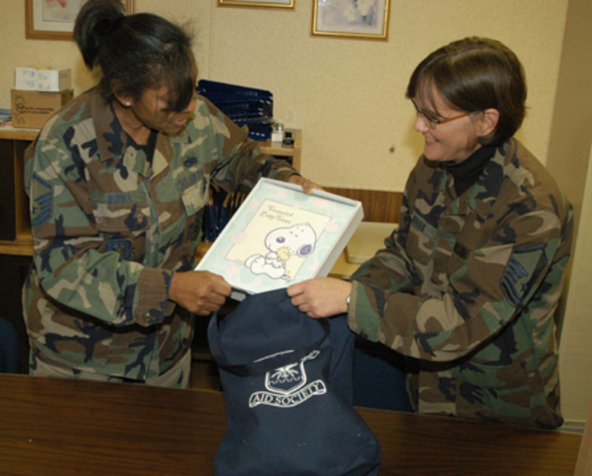 GRISSOM AIR RESERVE BASE, Ind., -- The family support center will host their quarterly "bundles for babies" during the primary unit training assembly in March. Family support specialists Master Sgt. Melissa Binns and Master Sgt. Sherry Burks prepare bundles for the upcoming event. (U.S. Air Force photo/Senior Airman Carl Berry)