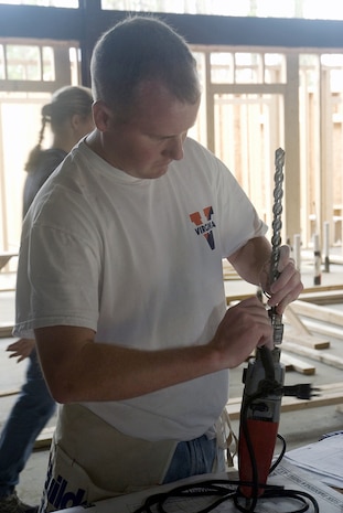 Capt. Ryan Zackrission, 14th Airlift Squadron, prepares to drill a hole in frame that will be a part of a wall in the Habitat for Humanity Restore in Jedburg S.C, Jan 11.  The Restore will sell donated item, and all profits from the store will be used to build homes for Habitat for Humanity. (U.S. Air Force photo by Staff Sgt. Jennifer Arredondo)