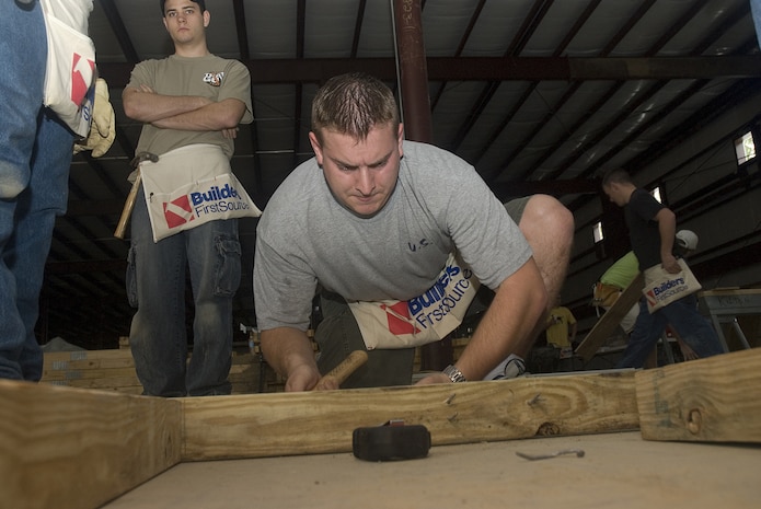 Airman 1st Class Jacob Lurvey, 437th Communitcations Sqaudron, hammers together a wall frame for the Habitat for Humanity Restore in Jedburg S.C., Jan 11.  According to Terry Epps, volunteer coordinator for Habitat for Humanity, stores like a restore helps community keep out large items from landfills, by taking donated items the store helps keep more than 70 millon pounds of unwanted items from landfills. (U.S. Air Force photo by Staff Sgt. Jennifer Arredondo)