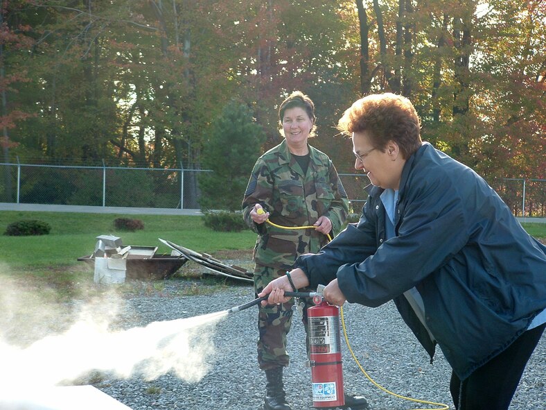 YOUNGSTOWN AIR RESERVE STATION, Ohio — Recently retired Air Force Reserve Master Sgt. Frances Taylor instructs Ms. Sandy Craghead, a civilian employee from the Eagle?s Nest lodging facility here in the proper way to use a fire extinguisher during a class in October 2004. U.S. Air Force/courtesy photo