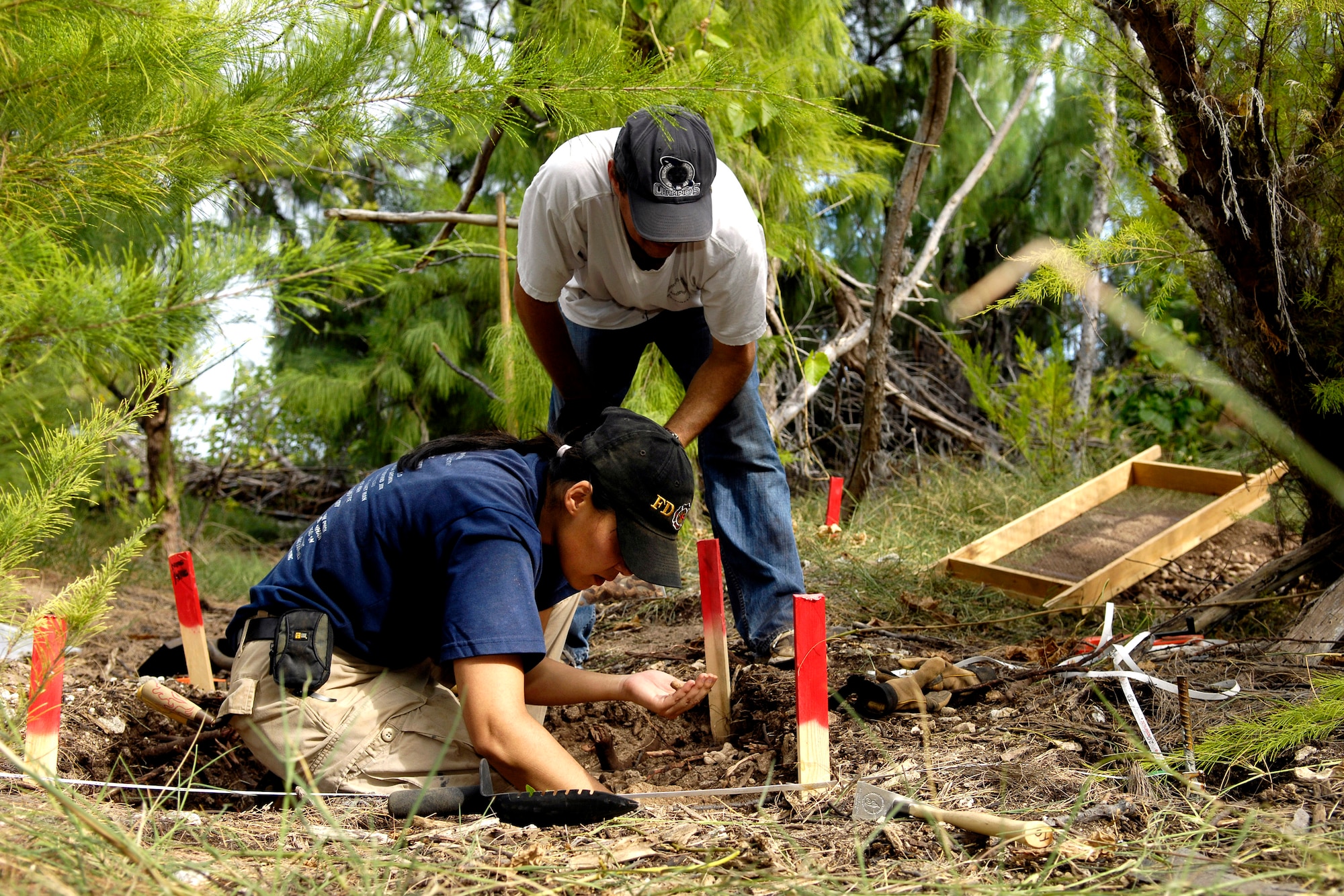 Greg Berg and Denise To excavate a dig site Jan. 12, 2008 on Wake Island. Mr. Greg and Ms. To, forensic anthropologists, were sent to do a site survey after Wake Island officials notified the Joint POW/MIA Accounting Command of bones located on the island. JPAC officials are charged with achieving the fullest possible accounting of all Americans missing as a result of past conflicts. (U.S. Air Force photo/Tech. Sgt. Shane A. Cuomo)
