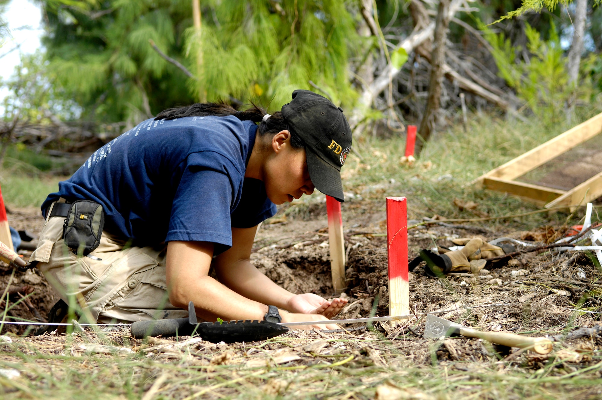 Denise To excavates a dig site Jan. 12 on Wake Island. Ms. To, a forensic anthropologist, was sent to do a site survey after Wake Island officials notified the Joint POW/MIA Accounting Command of bones located on the island. JPAC officials are charged with achieving the fullest possible accounting of all Americans missing as a result of past conflicts. (U.S. Air Force photo/Tech. Sgt. Shane A. Cuomo) 
