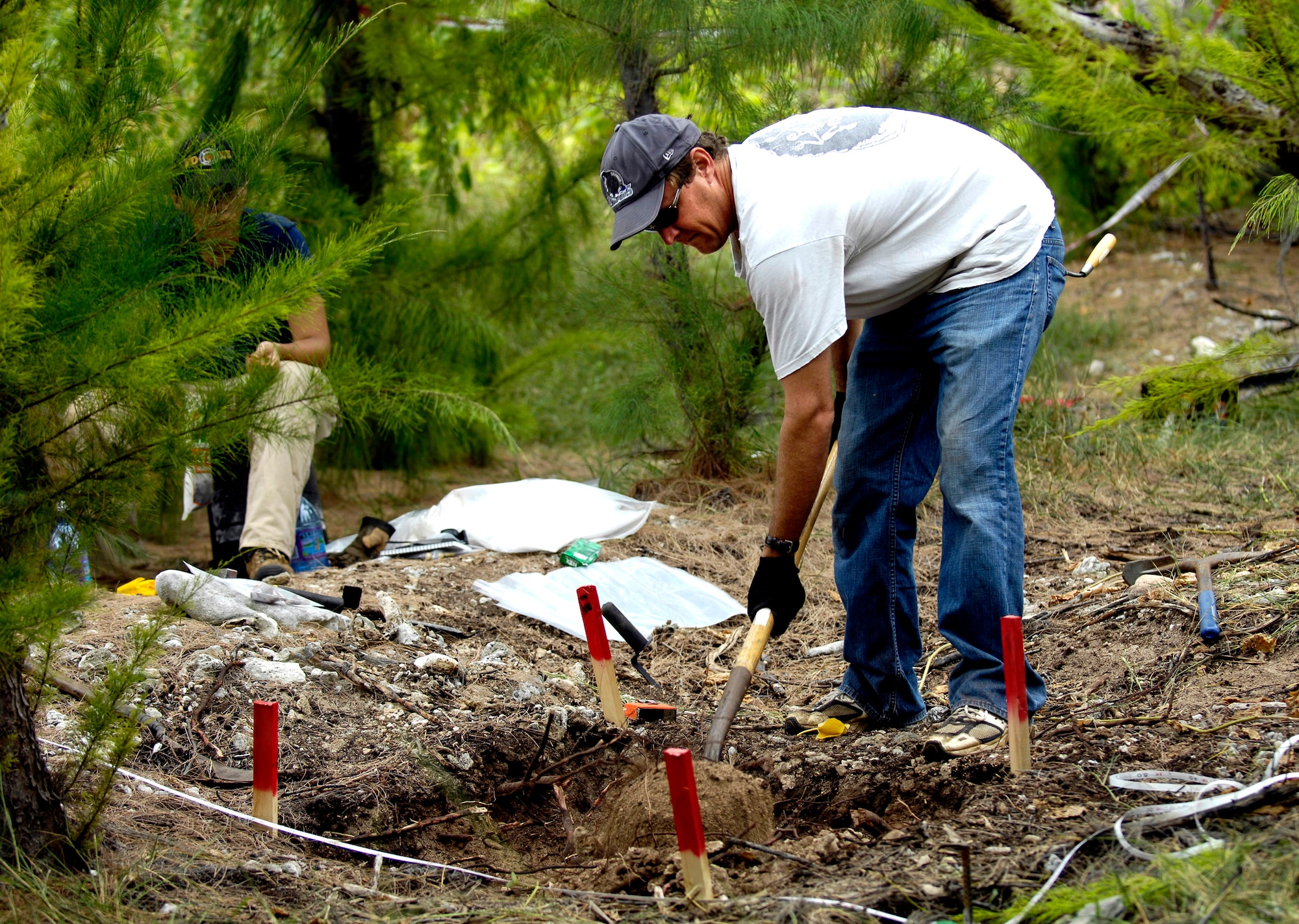Greg Berg excavates a dig site Jan. 12 on Wake Island. Mr. Berg, a forensic anthropologist, was sent to do a site survey after Wake Island officials notified the Joint POW/MIA Accounting Command of bones located on the island. JPAC officials are charged with achieving the fullest possible accounting of all Americans missing as a result of past conflicts. (U.S. Air Force photo/Tech. Sgt. Shane A. Cuomo) 
