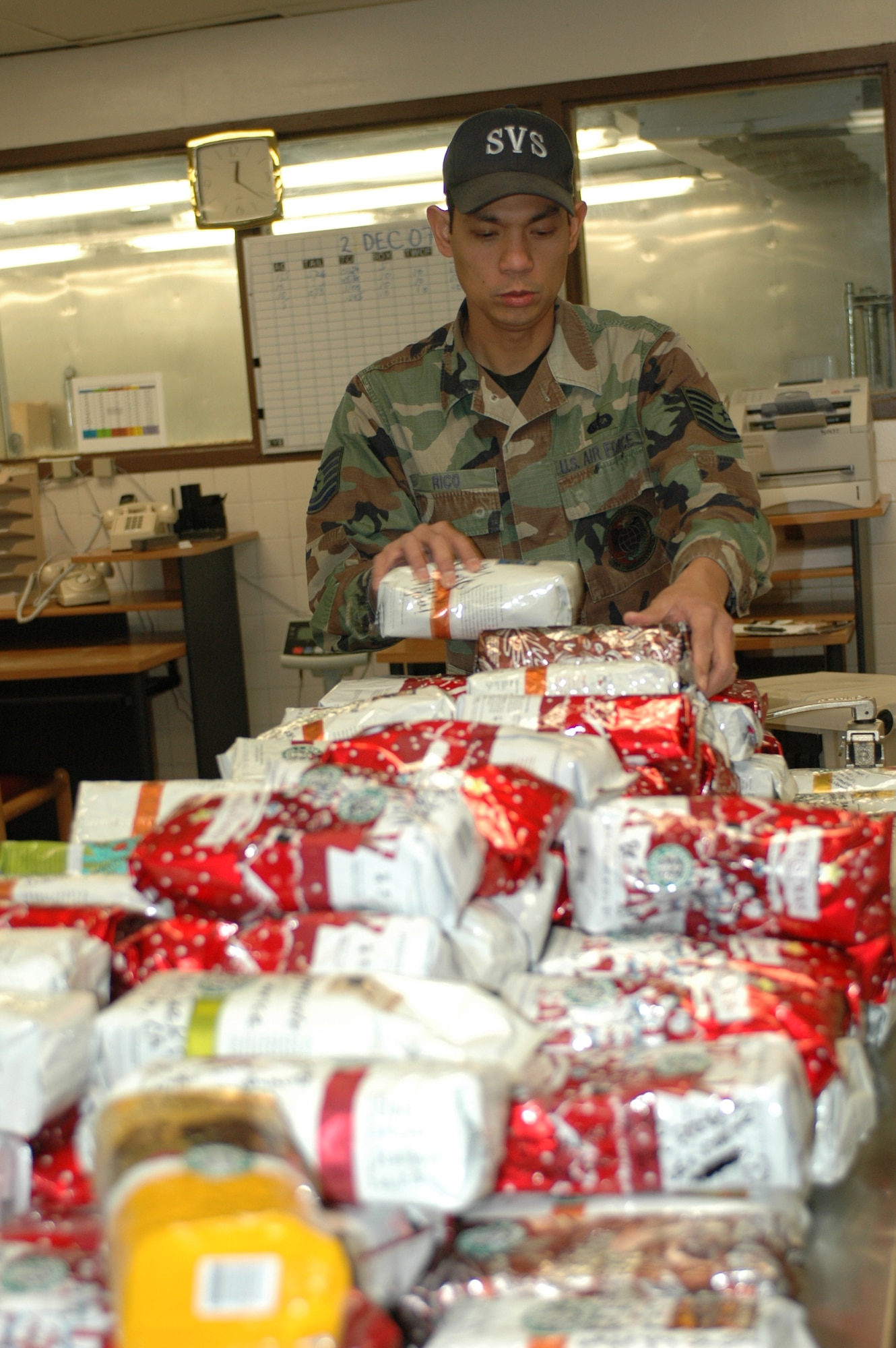 Tech Sgt. Willard Rico, 60th Services Squadron, counts and organizes coffee donated by Travis’ surrounding community. The coffee will be given to Travis Airmen and other military members fighting the Global War on Terror overseas. (U.S. Air Force photo/ Tech. Sgt. Matthew McGovern, 60th Air Mobility Wing Public Affairs)