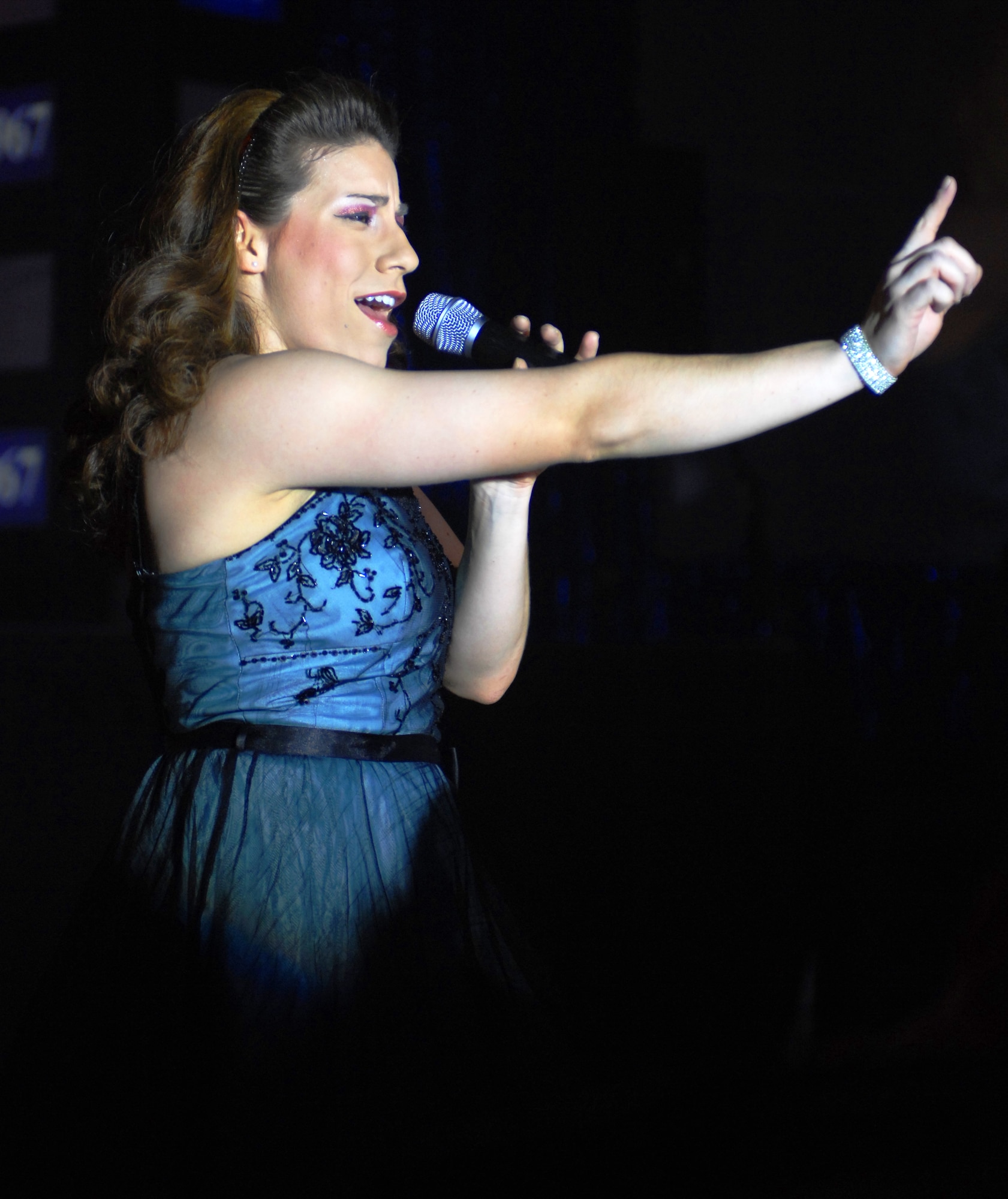 MOUNTAIN HOME AIR FORCE BASE, Idaho -- 1st Lt. Kimberly Robinson wows audience members with her singing and dancing during the Jan. 15 Tops in Blue show in Hangar 201 here. During the performance, Gunfighters welcomed back two performers who left Mountain Home Air Force Base a year earlier to start a one-year tour with the group. Senior Airman Benjamin Taylor, 366th Civil Engineer Squadron, and Tech. Sgt. Jennifer Dack, 366th Mission Support Squadron, were selected to join the team of singers, dancers, instrumentalists and stage hands who sing and dance their way through an average of 120 performances at 100 locations each year. The two Airmen first received news of their selection for the 2007 Tops in Blue team on Nov. 16, 2006, and have been touring around the world since. They returned here to perform the “The Fly-By,” A Musical Tribute to 60 Years of Proud Air Force History to Gunfighters. (U.S. Air Force photo/Airman 1st Class Ryan Crane)