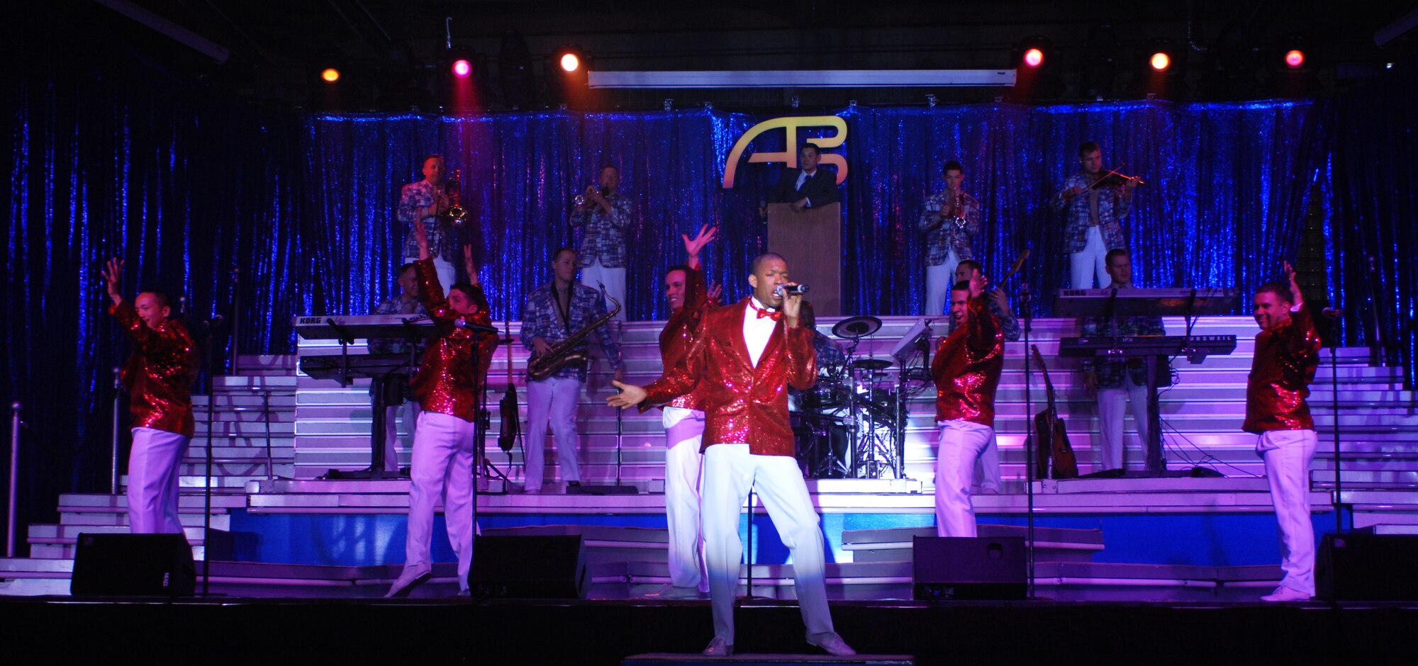 MOUNTAIN HOME AIR FORCE BASE, Idaho -- Senior Airman Tyrece Robertson and the Tops in Blues wow audience members with their singing during the Jan. 15 Tops in Blue show in Hangar 201 here. During the performance, Gunfighters welcomed back two performers who left Mountain Home Air Force Base a year earlier to start a one-year tour with the group. Senior Airman Benjamin Taylor, 366th Civil Engineer Squadron, and Tech. Sgt. Jennifer Dack, 366th Mission Support Squadron, were selected to join the team of singers, dancers, instrumentalists and stage hands who sing and dance their way through an average of 120 performances at 100 locations each year. The two Airmen first received news of their selection for the 2007 Tops in Blue team on Nov. 16, 2006, and have been touring around the world since. They returned here to perform the “The Fly-By,” A Musical Tribute to 60 Years of Proud Air Force History to Gunfighters. (U.S. Air Force photo/Airman 1st Class Ryan Crane)