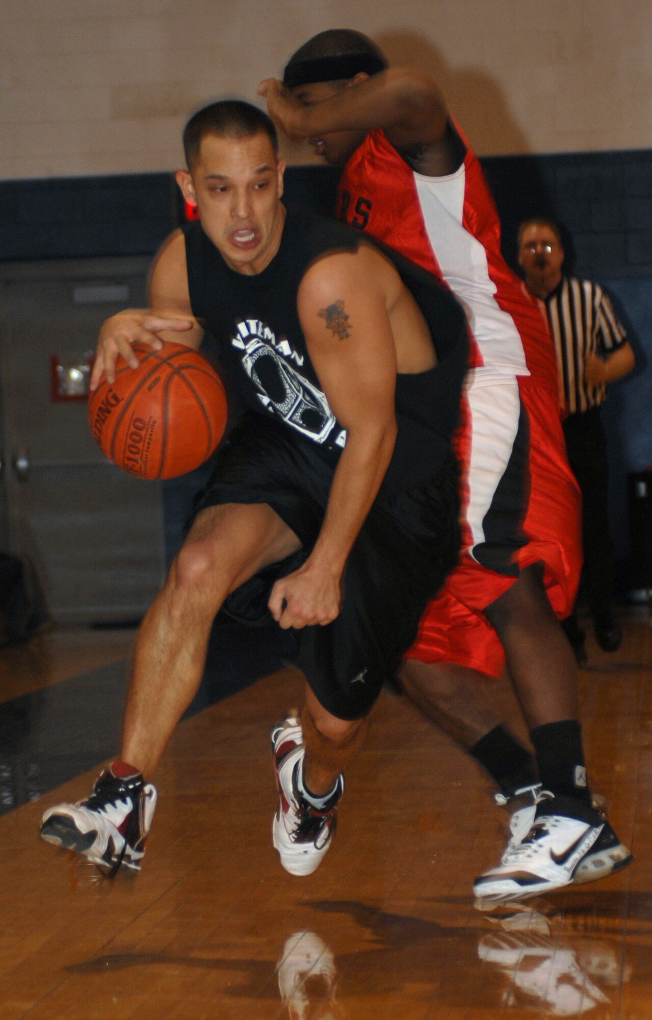 WHITEMAN AIR FORCE BASE, Mo. - Staff Sgt. Jesse Swiderek, 509th Maintenance Squadron, drives hard down the court after getting a rebound during a game against Sheppard Air Force Base at the base gym Jan. 12. Sheppard beat Whitman 115- 97 on Jan. 12 and Whiteman came back Jan. 13 and defeated Sheppard with a score of 82- 78 bring their record to 4 and 6. (U.S. Air Force photo/Airman 1st Class Jessica Snow)