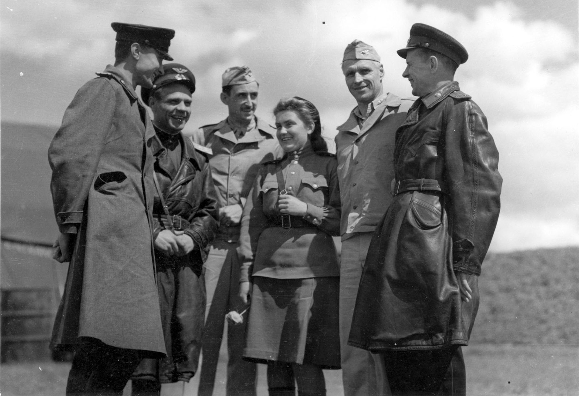 Russian officers chat with Col. Barton, commanding officer of the 483rd Bomb Group, and Col. Rice of the 2nd Bomb Group at Mirgorod. The girl in the center is an interpreter. (U.S. Air Force photo)