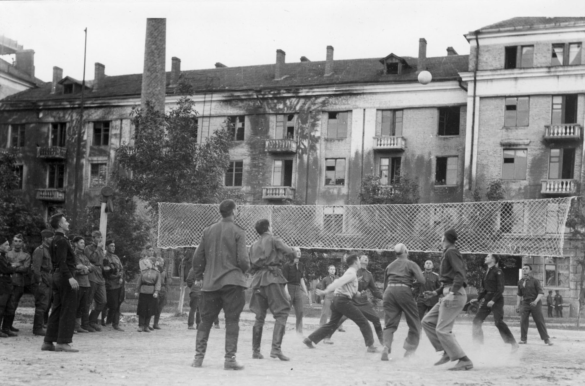 The Soviets turned out to be expert volleyball players, and every night in the courtyard of Eastern Command HQ at Poltava, there were fast mixed games. Player fifth from the right at bottom is Gen. Ira Eaker. (U.S. Air Force photo)