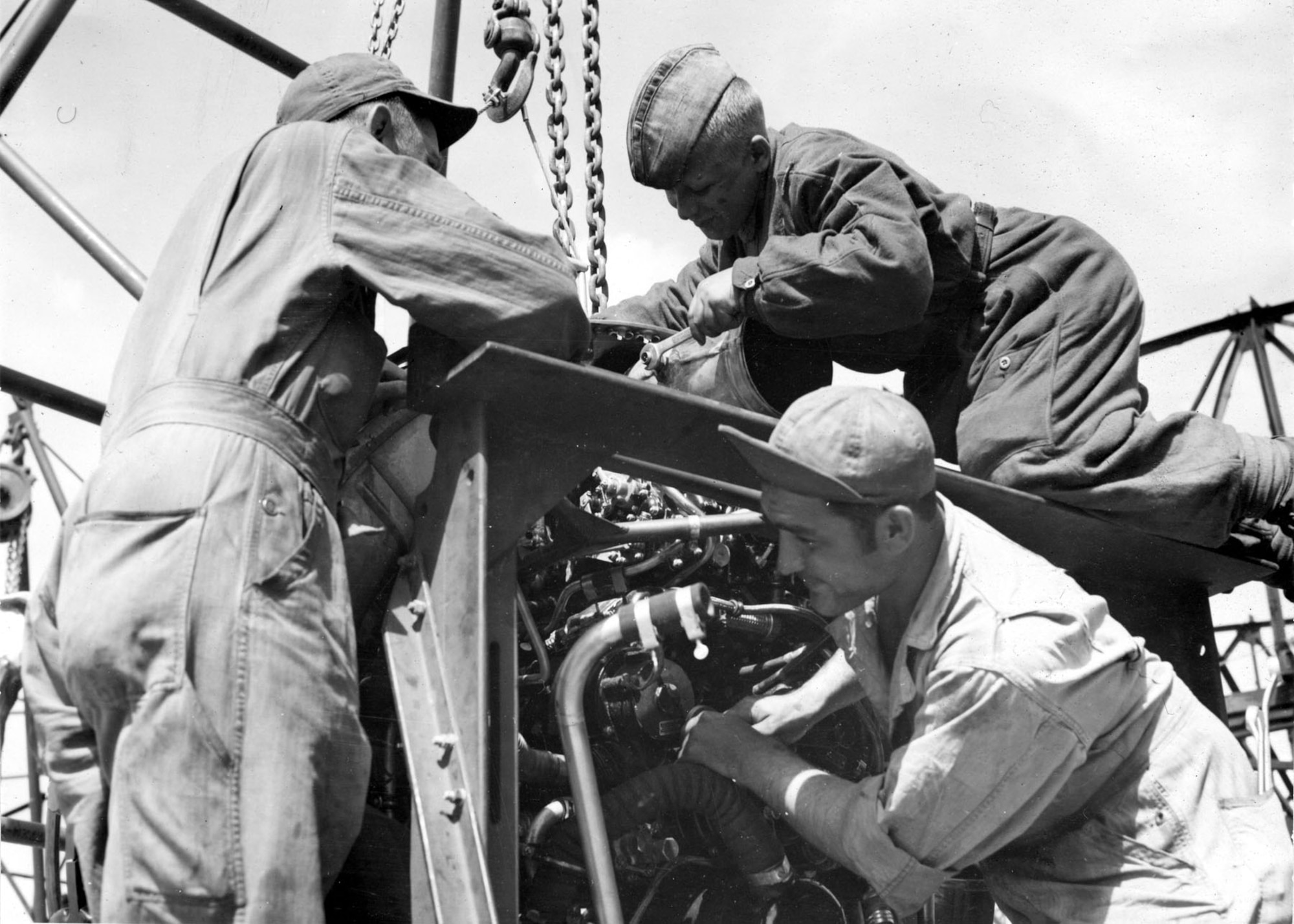 MSgt. John M. Bassett, Lenin Boykov of Leningrad, and MSgt. Michael Cajolda service a visiting task force bomber. (U.S. Air Force photo)