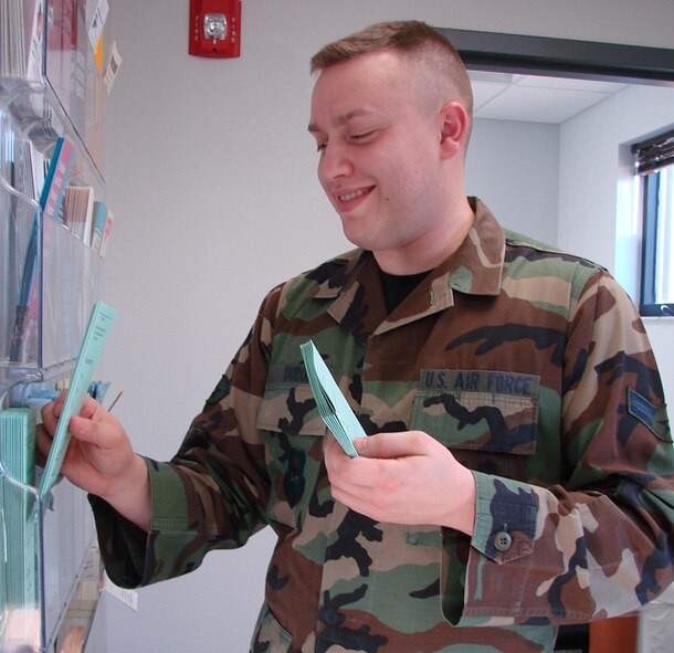 Airman 1st Class Robert DuBois, Mental Health technician, places informational brochures in the waiting room of the new Mental Health Services building located at 816 Macchia Ave.  Team Vance members are invited to attend the ribbon-cutting ceremony for the new facility at 10 a.m., Jan. 22. (U.S. Air Force photo by Tech. Sgt. Mary Davis)