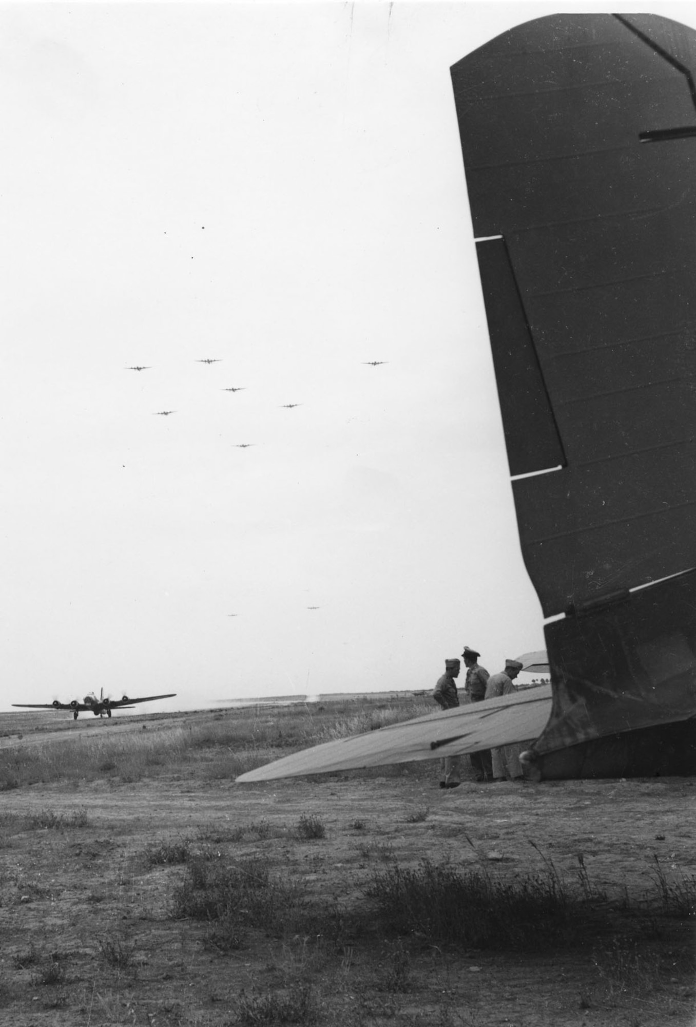 97th and 99th Bomb Group B-17s return to Amendola Airfield, Italy, from the first shuttle mission to Russia. Gen. Ira Eaker’s C-35 awaits him at right, June 11, 1944. (U.S. Air Force photo)