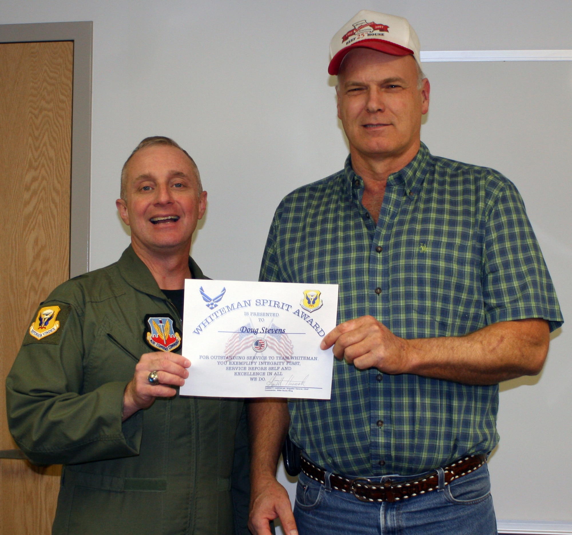 WHITEMAN AIR FORCE BASE, Mo. - Doug Stevens, 509th Civil Engineer Squadron, receives the Whiteman Spirit Award from Brig. Gen. Garrett Harencak, 509th Bomb Wing commander, Jan. 7.  (U.S. Air Force photo/ 1st Lt. Candace Cutrufo)