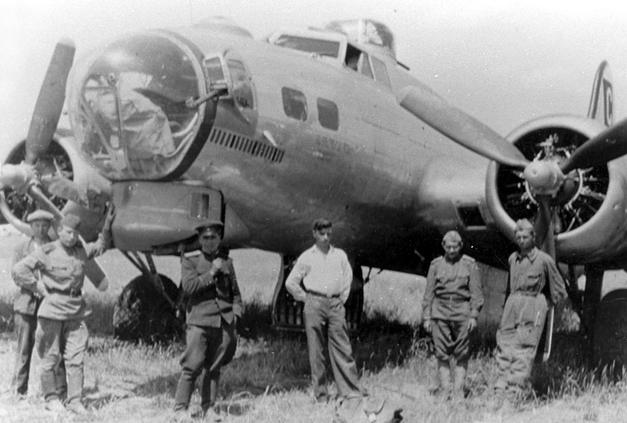 Badly damaged B-17 bomber and Russian soldiers in Poltava, Russia, on June 22, 1944. (U.S. Air Force photo)
