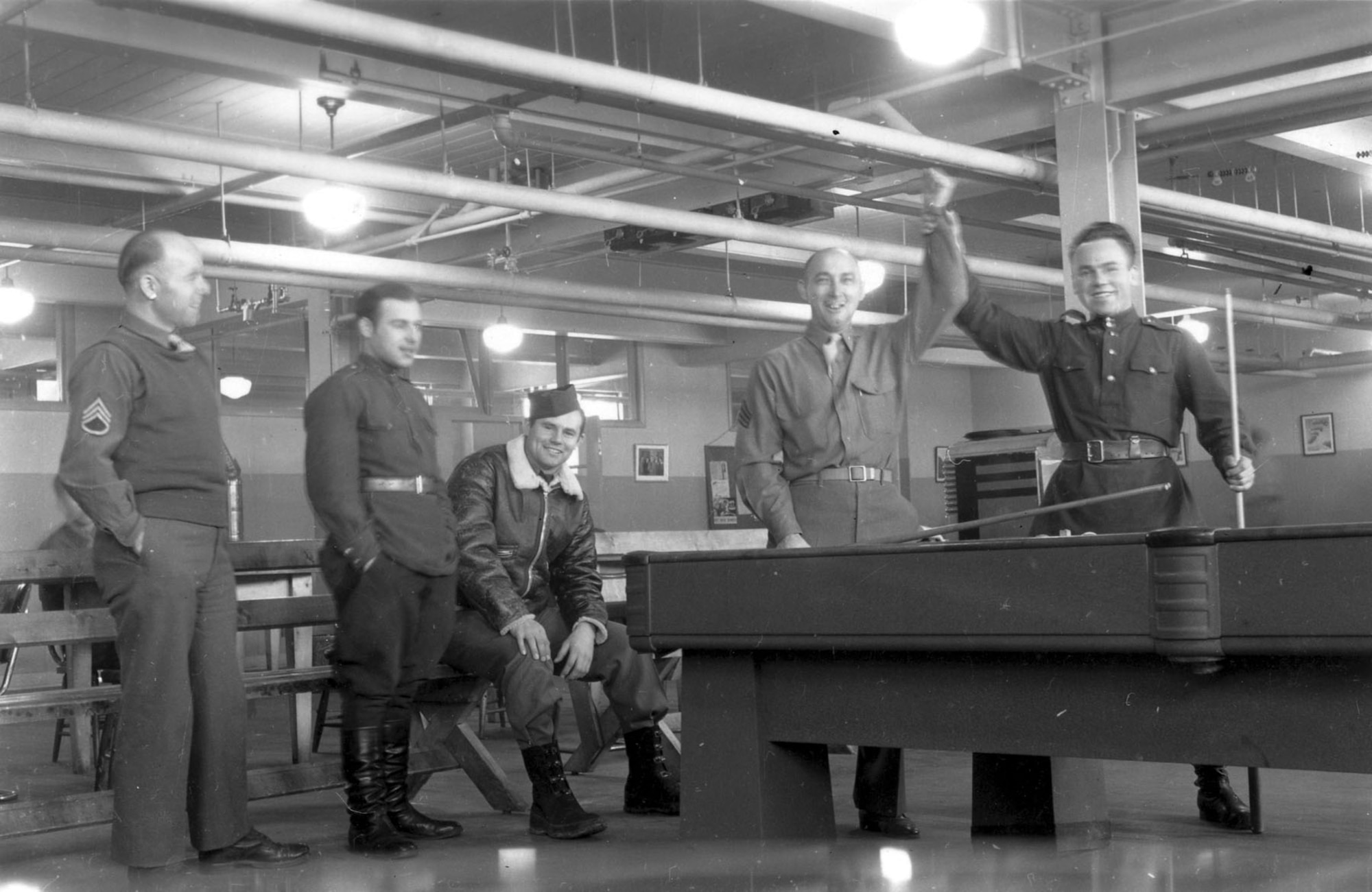 American and Soviet airmen pose during a game of billiards. This photo was taken in Alaska during American-Soviet lend-lease operations. (U.S. Air Force photo)
