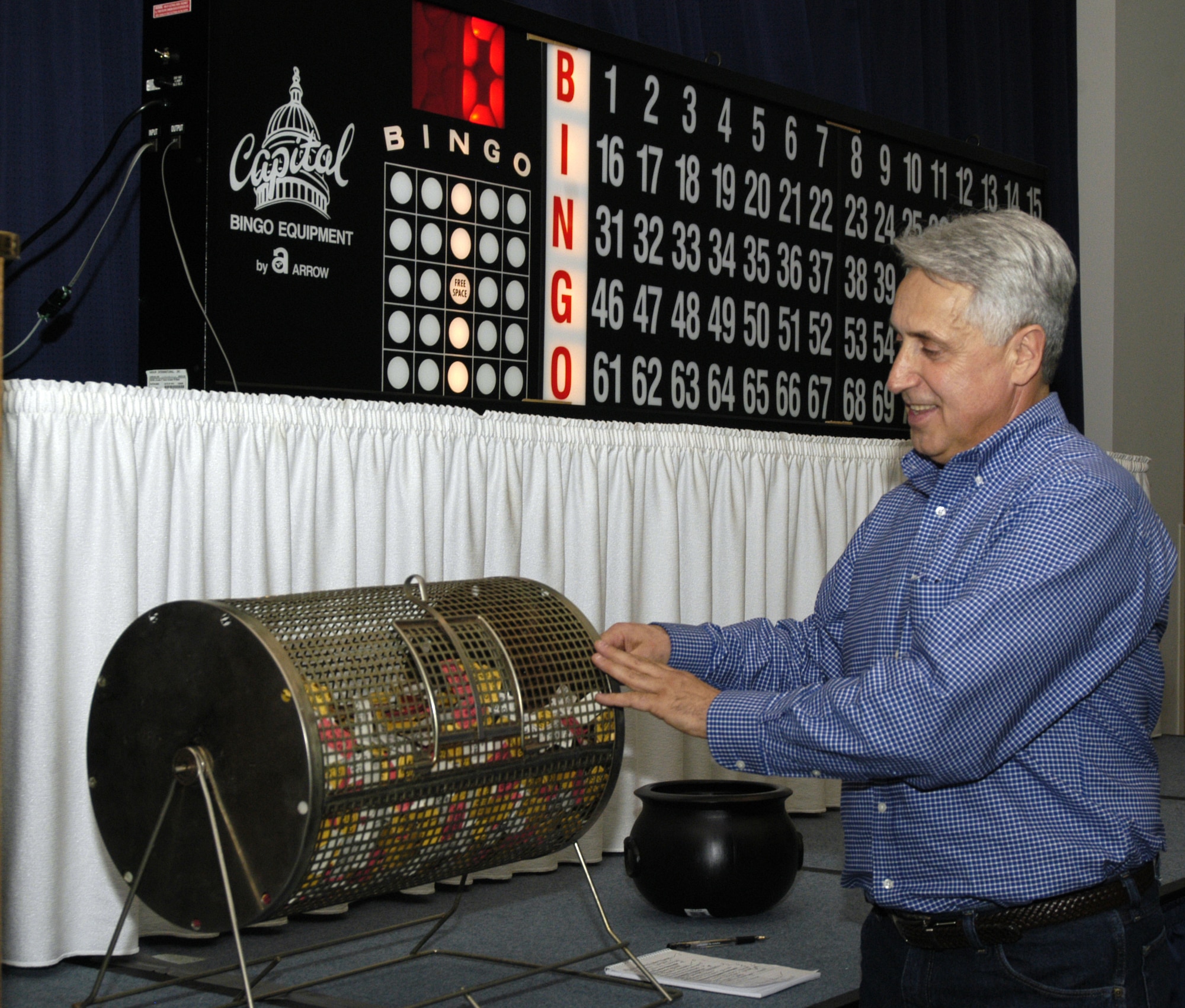Frank Russo, 436th Services Squadron Community Center director, draws for a ticket to announce winners to receive a prize at the Super Bowl Bingo event Jan. 12, at The Landings Club.(U.S. Air Force photo/ Airman Shen-Chia Chu) 
