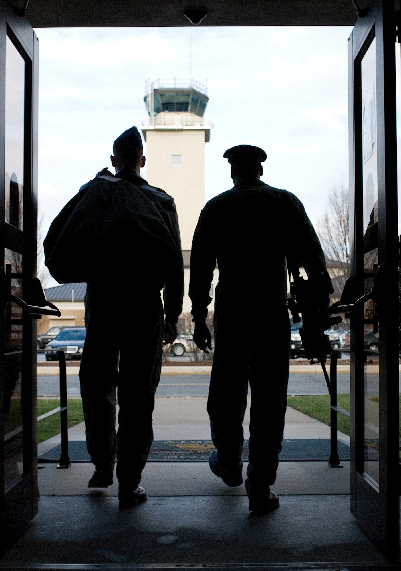 (Left) Staff Sgt. Chris Copans, 3rd Airlift Squadron C-17 loadmaster walks side-by-side with Airman 1st Class Jovanny Reyes, 436th Security Forces Squadron Raven. (U.S. Air Force photo/ Roland Balik)