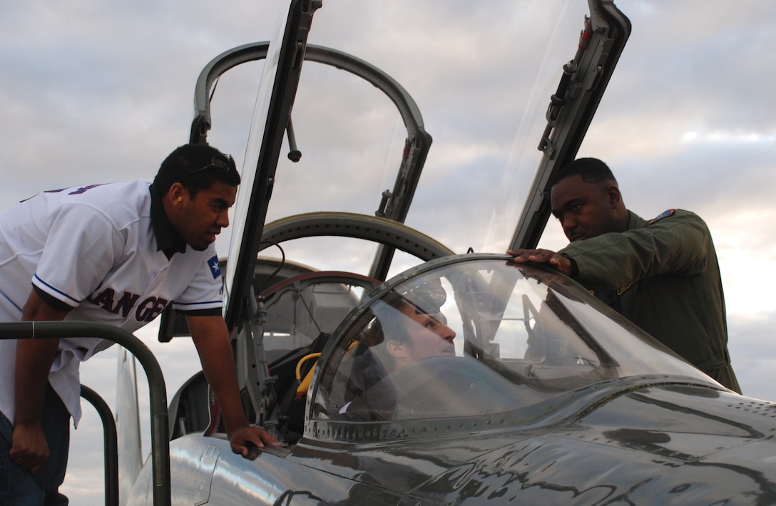 Lt. Col. Ternell Washington, 80th Flying Training Wing, shows the inside of a T-38C Talon to Wes Littleton (left), a pitcher with the Texas Rangers baseball team, and Travis Metcalf, a third baseman with the Texas Rangers Jan. 15.  (U.S. Air Force photo/Airman 1st Class Jacob Corbin)
