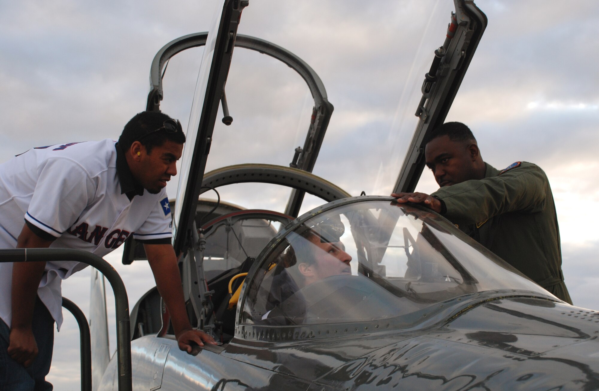 Lt. Col. Ternell Washington, 80th Flying Training Wing, shows the inside of a T-38C Talon to Wes Littleton (left), a pitcher with the Texas Rangers baseball team, and Travis Metcalf, a third baseman with the Texas Rangers Jan. 15.  (U.S. Air Force photo/Airman 1st Class Jacob Corbin)