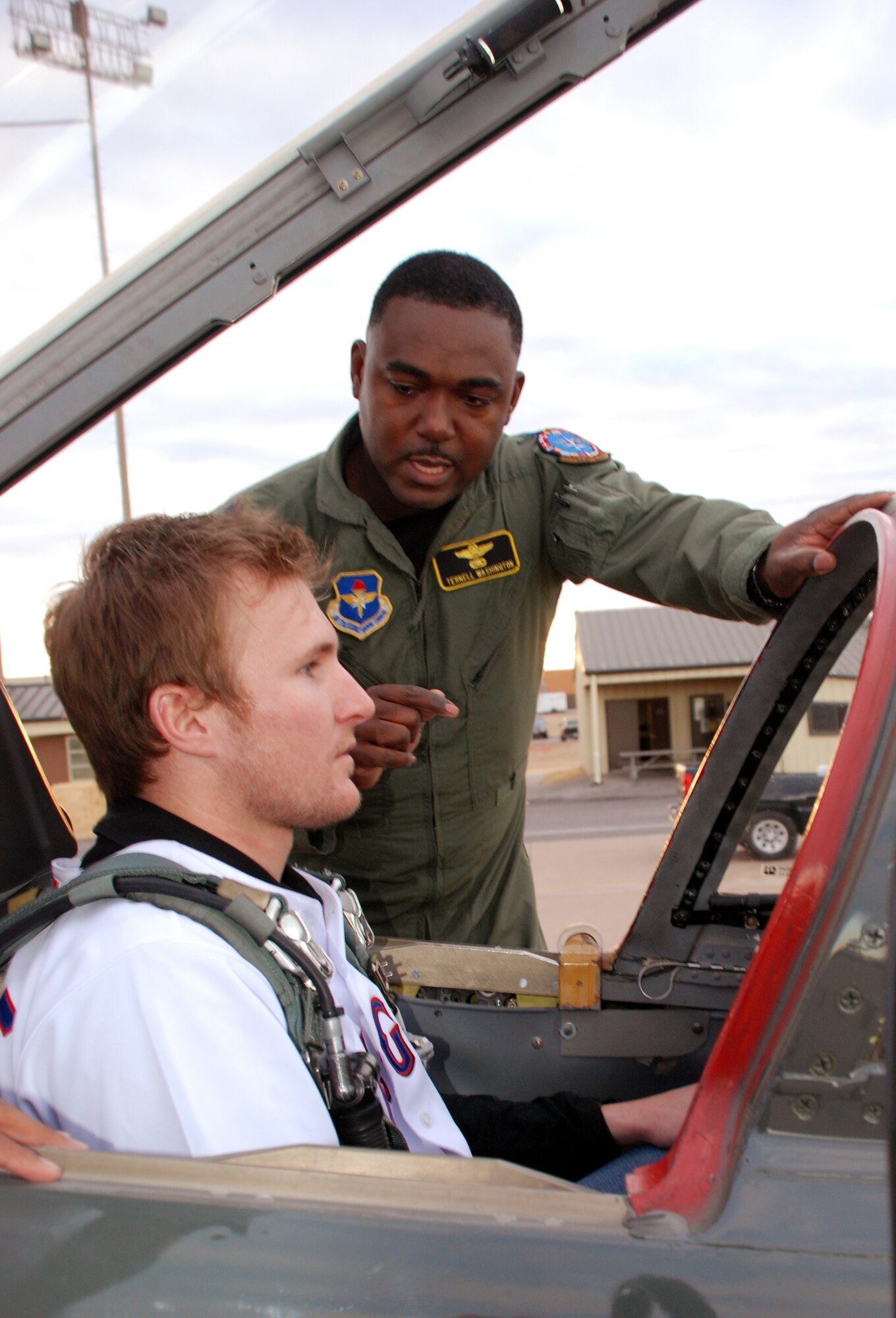 Lt. Col. Ternell Washington, 80th Flying Training Wing, shows the inside of a T-38C Talon to Travis Metcalf, a third baseman with the Texas Rangers baseball team Jan. 15. Metcalf was one of two Texas Ranger's players that visited Sheppard. (U.S. Air Force photo/Airman 1st Class Jacob Corbin)