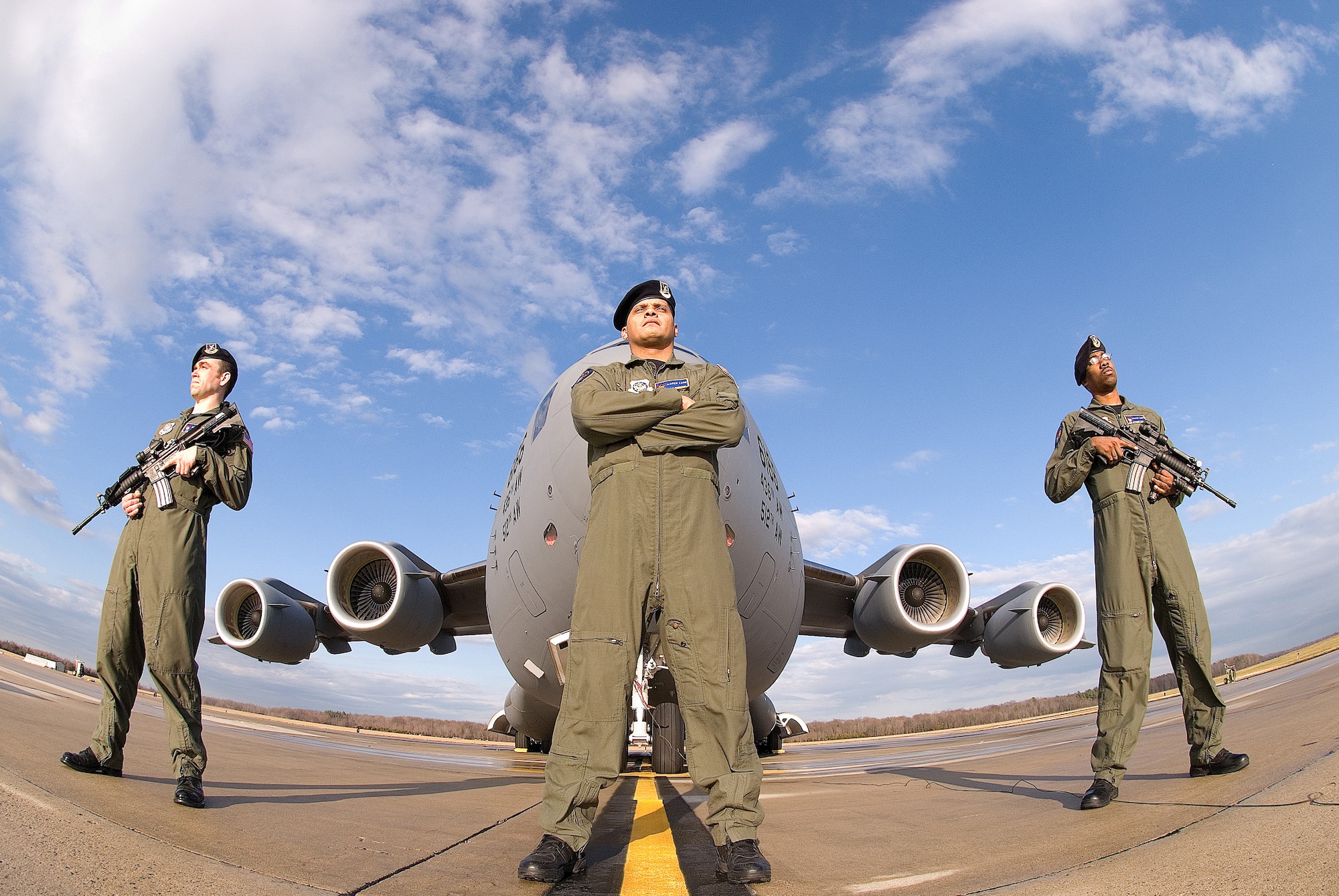 Airman 1st Class James New, Tech. Sgt. Michael Hernandez and Airman 1st Class Jovanny Reyes, 436th Security Forces Squadron Ravens, stand guard in front of a C-17 Jan. 11 on the flightline at Dover Air Force Base. (U.S. Air Force photo/ Roland Balik)