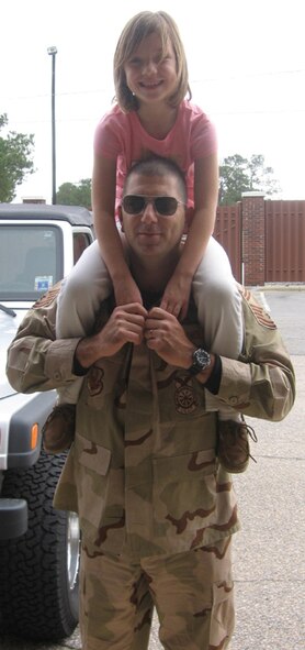 SEYMOUR JOHNSON AIR FORCE BASE, N.C.--Senior Master Sgt. Donald Knuth gives his daughter one last ride before he leaves with other members of the 916th Civil Engineer Squadron for their Air Expeditionary Force time in Iraq.  Sergeant Knuth is deputy fire chief with the 916th CES. U.S. Air Force photo/Courtesy