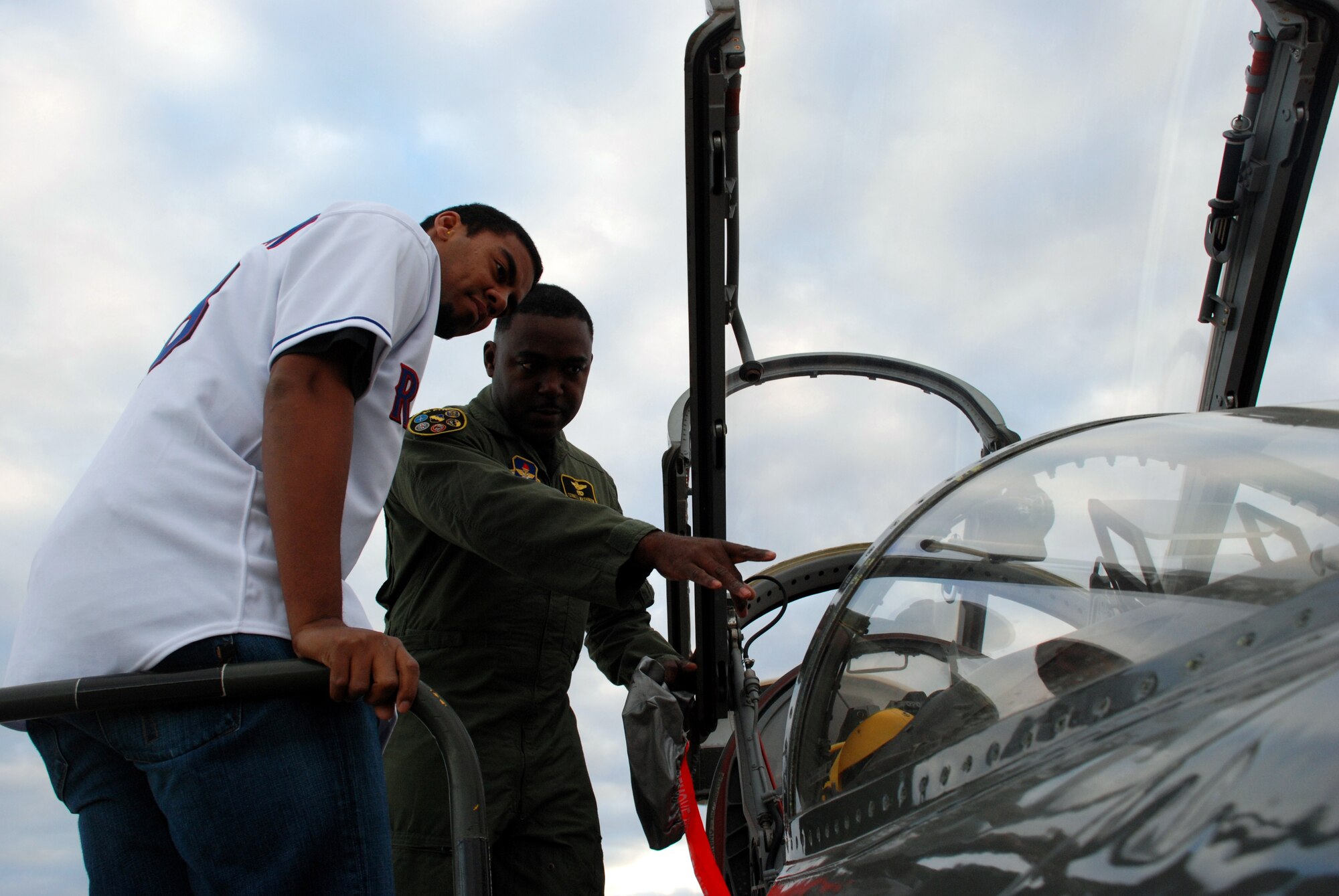 Lt. Col. Ternell Washington, 80th Flying Training Wing, shows the inside of a T-38C Talon to Wes Littleton, a pitcher with the Texas Rangers baseball team Jan. 15. Littleton was one of two Texas Ranger's players that visited Sheppard. (U.S. Air Force photo/Airman 1st Class Jacob Corbin)