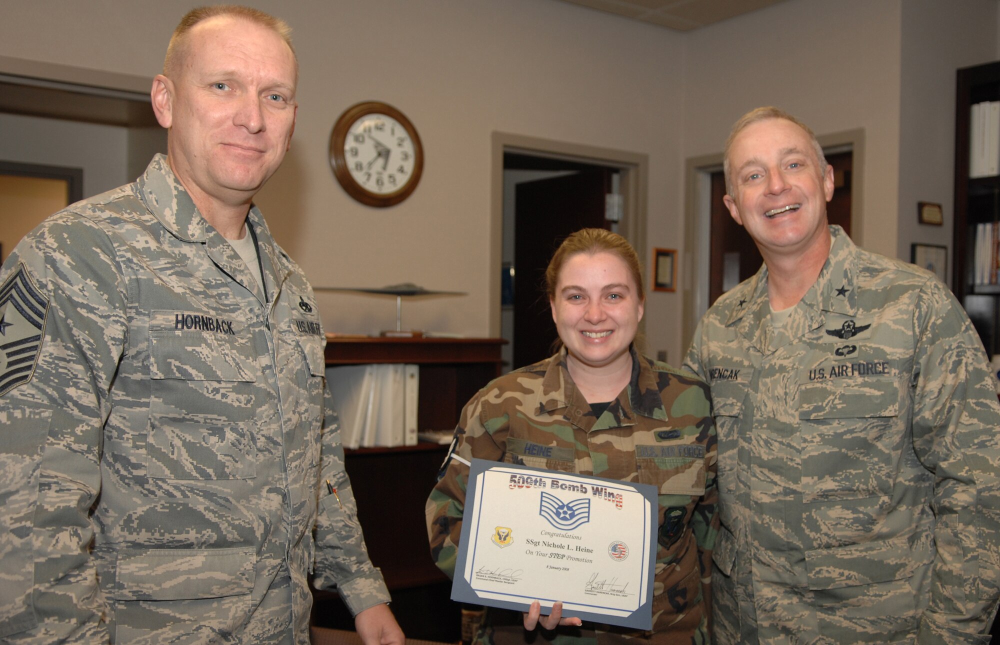 WHITEMAN AIR FORCE BASE, Mo. – Staff Sgt. Nichole Heine, 509th Operations Group, Brig. Gen. Garrett Harencak, 509th Bomb Wing commander and Chief Master Sgt. Brian Hornback, 509th Bomb Wing command chief master sergeant, pose for a photo after Staff Sgt. Heine is Stripes for Exceptional Performance promoted to technical sergeant Jan. 11. STEP promotions are reserved for staff sergeants to master sergeants, and presented selectees who have had approved recommendations by their commanders and meet the following criteria: candidates have performed outstanding in their duty section, are involved in off-duty activity in local communities, worked on self-improvement, and have been recognized for their job or non-duty performance. (U.S. Air Force photo/Airman 1st Class Jessica Snow)

