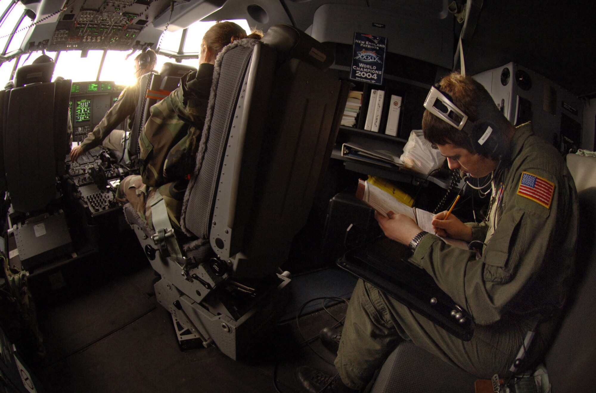 Rhode Island Air National Guard Loadmaster Staff Sgt. Joseph Maker annotates weight and balance figures before departure from Ramstein Jan. 9. The crew, flying for the 38th Airlift Squadron, is enroute to Aviano Air Base, Italy, where they'll pick up and deliver cargo to Zaragoza Air Base, Spain, in support of an F-16 Falcon training exercise. Photo by Master Sgt. Scott Wagers / (released)