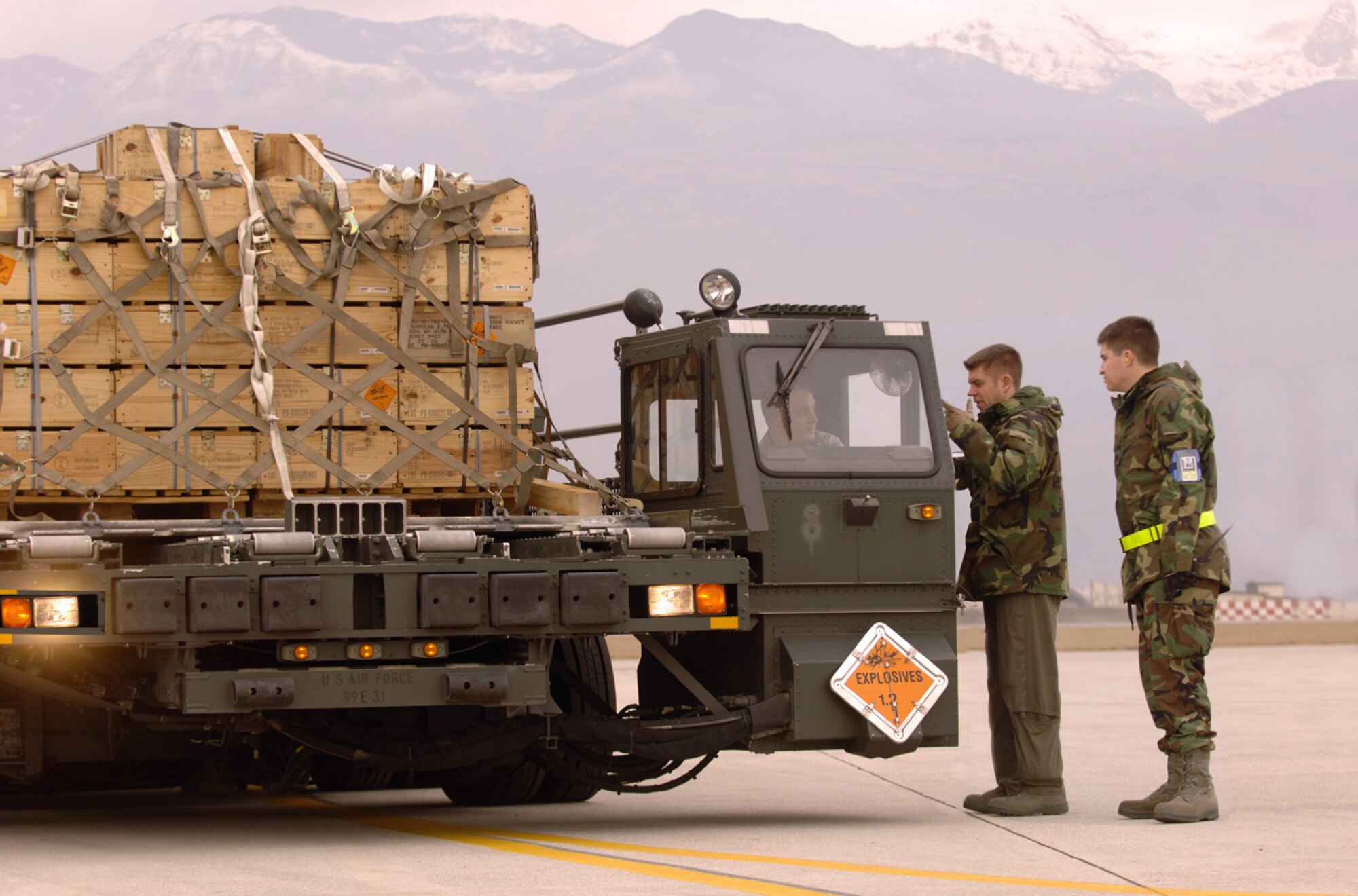 At Aviano Air Base, Italy, C-130J loadmaster Tech. Sgt. Kyle Gurnon, discusses the upload of munitions with Senior Airman Joseph Gingo that will be transported to Zaragoza Air Base, Spain. Sergeant Gurnon and Rhode Island Air National Guard-based crew are TDY to the 38th Airlift Squadron at Ramstein from the 143rd Airlift Wing at Quonset State Airport near Providence, R.I. Photo by Master Sgt. Scott Wagers / (released)