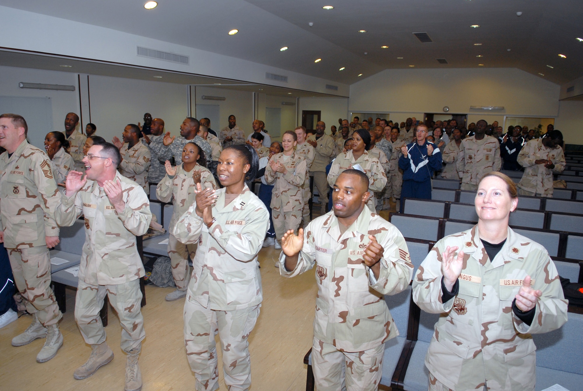 SOUTHWEST ASIA-- The audience at the 379th Air Expeditionary Wing Victory Chapel's Martin Luther King Jr. Celebration participates in song and clapping as they sing "We Shall Overcome" Jan. 15 at a Southwest Asia air base. (U. S. Air Force photo/Senior Airman Domonique Simmons)