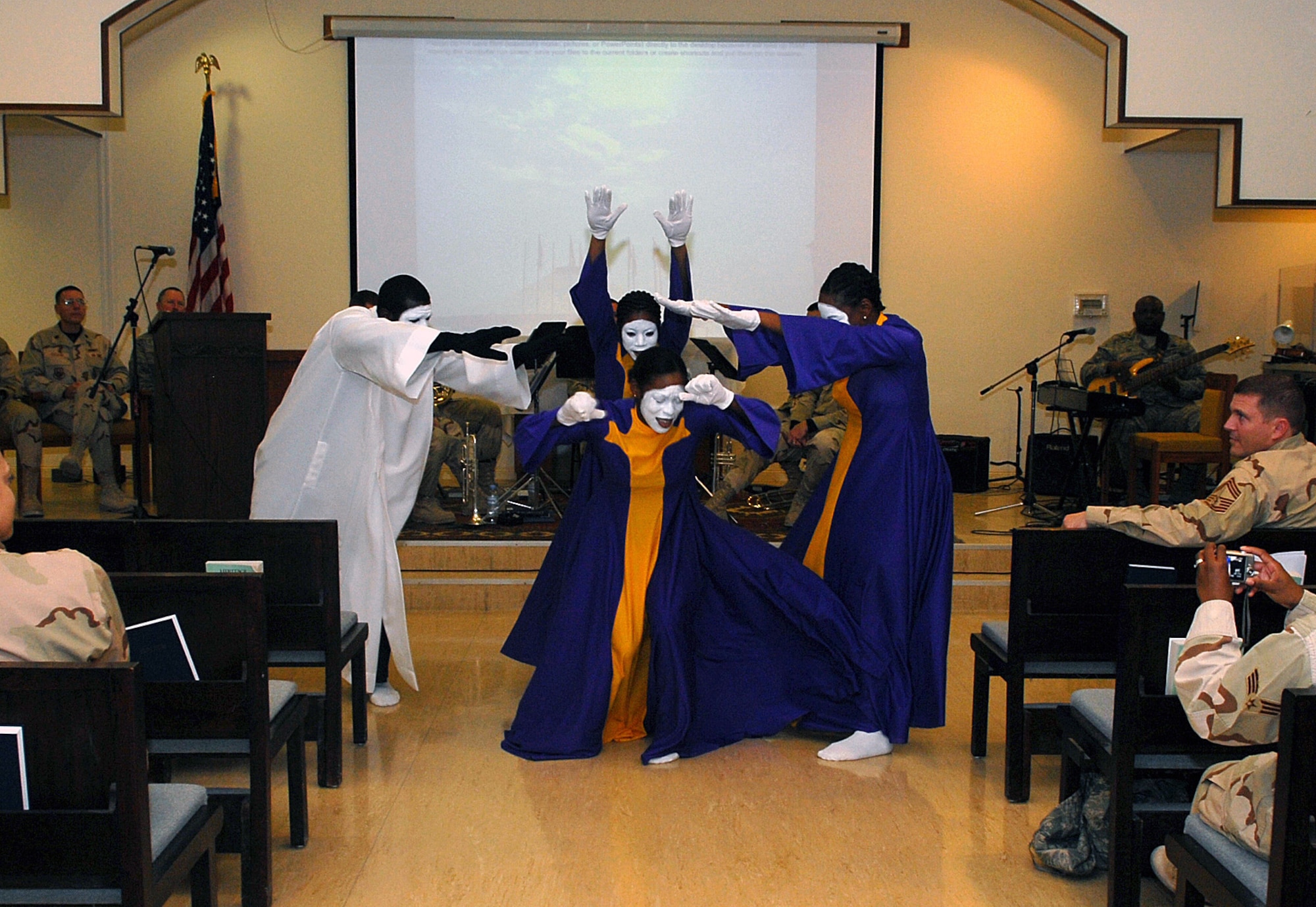 SOUTHWEST ASIA-- The  379th Air Expeditionary Wing Victory Chapel Gospel service dancers perform for a Martin Luther King Celebration event by "praise dancing", an expressive form of worship, Jan. 15 at a Southwest Asia air base. The celebration included song selections from the Community Choir, words of remembrance from Chaplain (Capt.) Corwin Smith and music selections from the US CENTAF band "Hot Brass". (U. S. Air Force photo/Senior Airman Domonique Simmons)