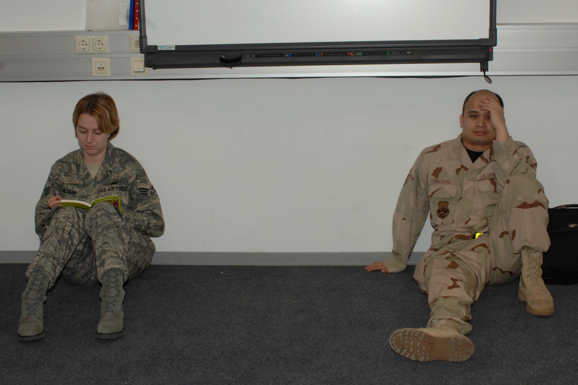 SPANGDAHLEM AIR BASE, Germany – Senior Airman Kim Coleman, 435th Services Squadron, and Staff Sgt. Kane Palomo, 435th Munitions Maintenance Squadron, relax until their bus arrives after receiving their final deployment outprocessing briefing Jan. 15, 2008. Airman Coleman is assigned to Ramstein Air Base, Germany. Sergeant Palomo is assigned to Sembach Air Base, Germany. (U.S. Air Force photo/Airman 1st Class Jenifer Calhoun)