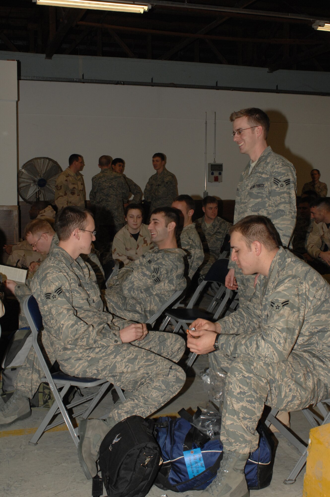 SPANGDAHLEM AIR BASE, Germany – After receiving their final deployment outprocessing briefing, Airmen from the 606th Air Control Squadron patiently wait for a bus to take them to the 726th Air Mobility Squadron terminal Jan. 15, 2008. (U.S. Air Force photo/Airman 1st Class Jenifer Calhoun)