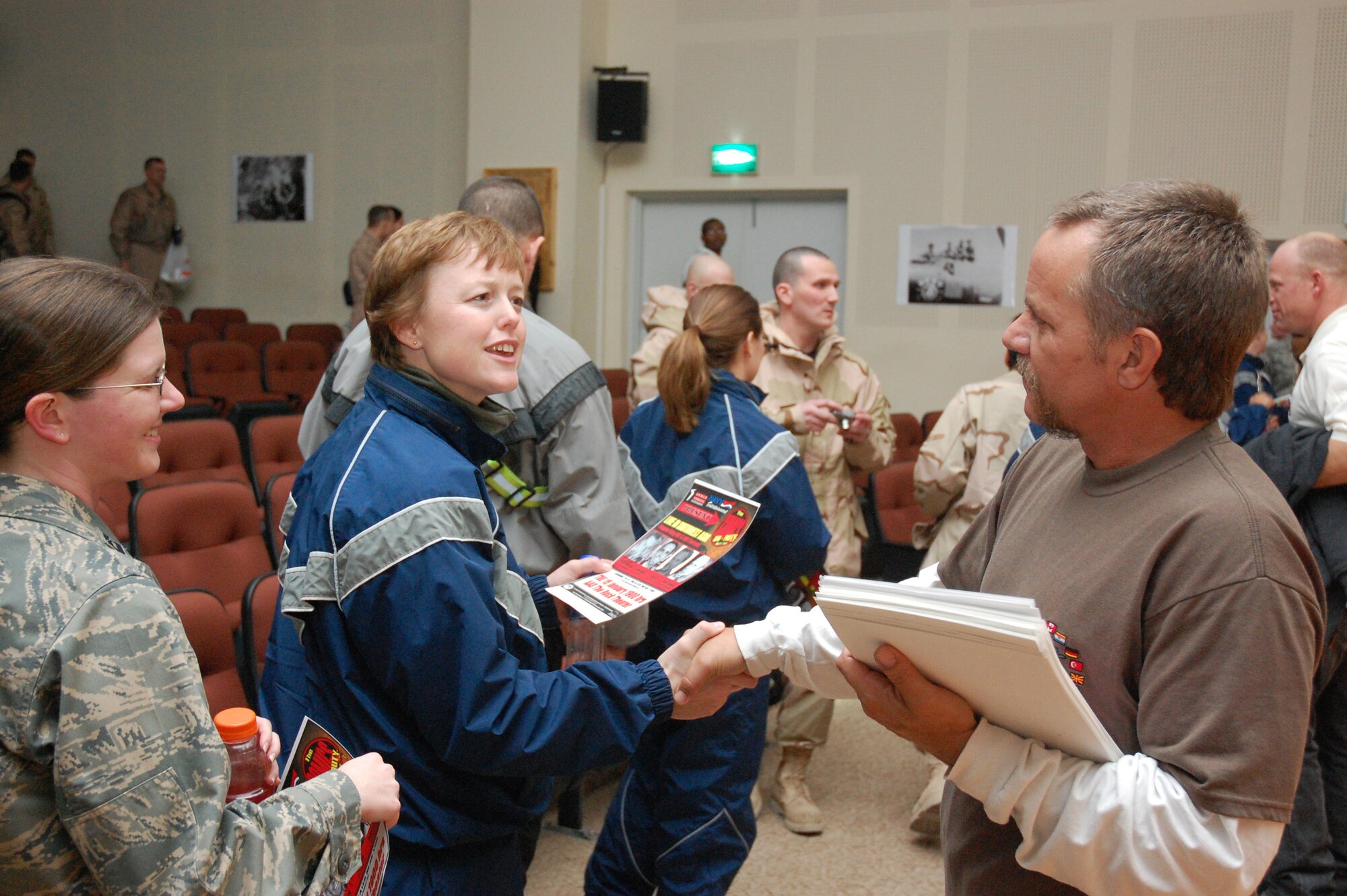 Tom Foss, a comedian on the Comics on Duty World Tour, greets Airmen Jan. 15,  2007, at an air base in the Persian Gulf Region. Mr. Foss and fellow comedians Robert Hawkins, Jesse Joyce and Keith Alberstadt spent time socializing with Airmen and signing autographs after their performance. (U.S. Air Force photo/Capt Jason L. McCree) (Released)