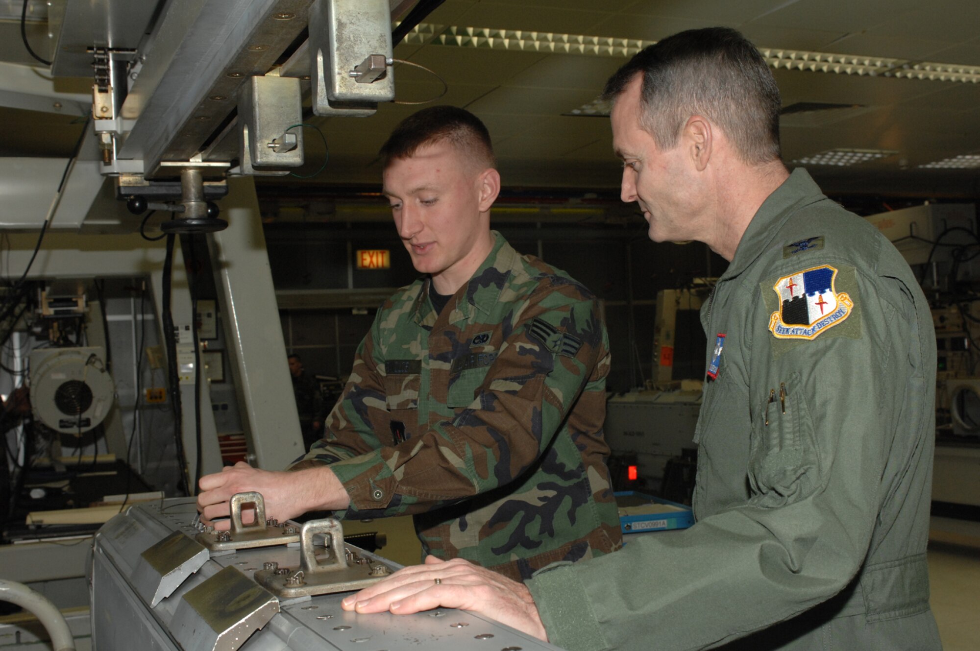 SPANGDAHLEM AIR BASE, Germany – Col. Darryl Roberson, 52nd Fighter Wing commander, assists Senior Airman William Reynolds, 52nd Component Maintenance Squadron, as he prepares to hang an ALQ 131 electronic counter measures pod. Airman Reynolds is an electronic warfare technician who is responsible for inspecting, repairing and maintaining ALQ 131 ECM pods and test stations. (U.S. Air Force photo/Airman 1st Class Jenifer Calhoun)