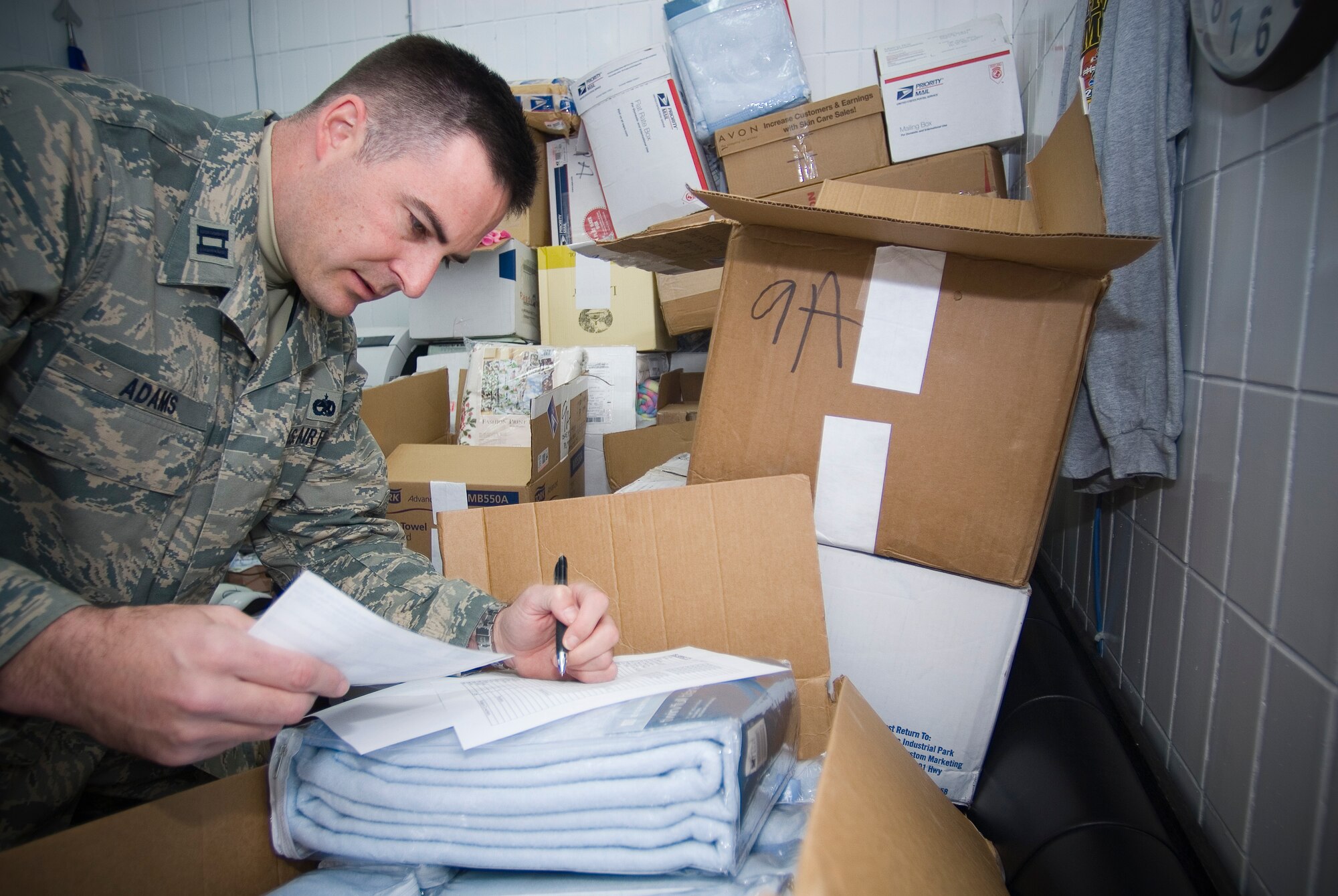 BALAD AIR BASE, Iraq -- Capt. Taylor Adams, 721st Aircraft Mobility Operations Group, Detachment 5 commander, inventories the blankets he's received as donations for patients at the Air Force Theater hospital here, Jan. 16. Captain Adams is meticulous about sending thank-yous home to people who donate blankets for injured American and Iraqi patients. The captain is a member of the Air Force Reserve deployed from Charleston Air Force Base, S.C. (U.S. Air Force photo/Master Sgt. John R. Nimmo, Sr.)