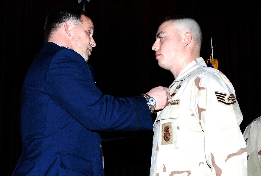 FAIRCHILD AIR FORCE BASE, Wash. – Col. Thomas Sharpy, 92nd Air Refueling Wing commander, presents Staff Sgt. John Stolz, 92nd Security Forces Squadron, the Soldier’s Medal on Jan. 15 at the base theater. (U.S. Air Force photo/Staff Sgt. JT May III)